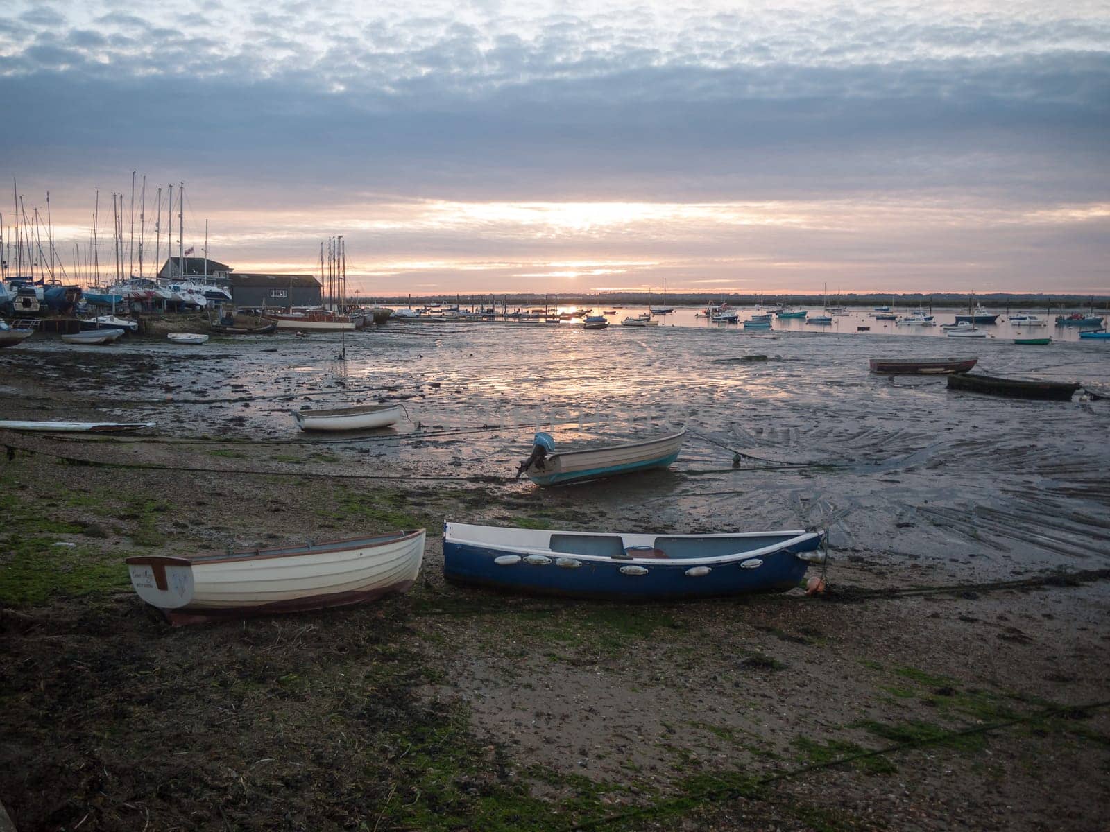 sun set sky dramatic clouds sea front beach harbor marina boats moored landscape  west mersea, essex, england, uk