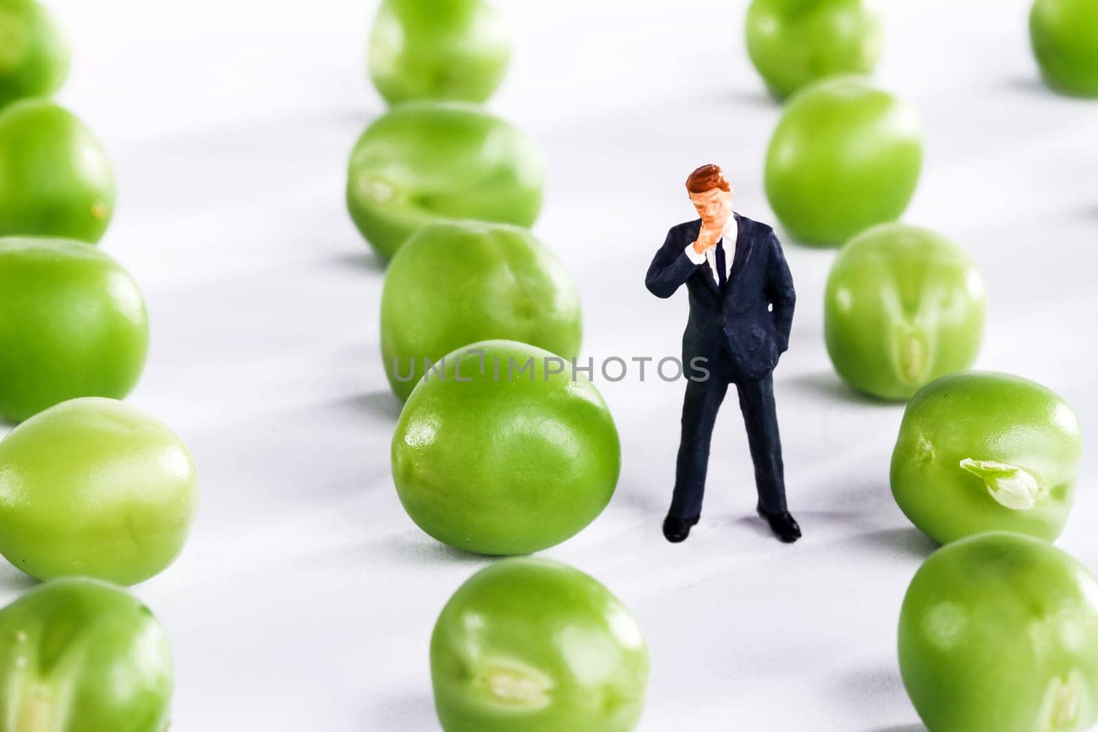 Figure of a businessman with fresh peas