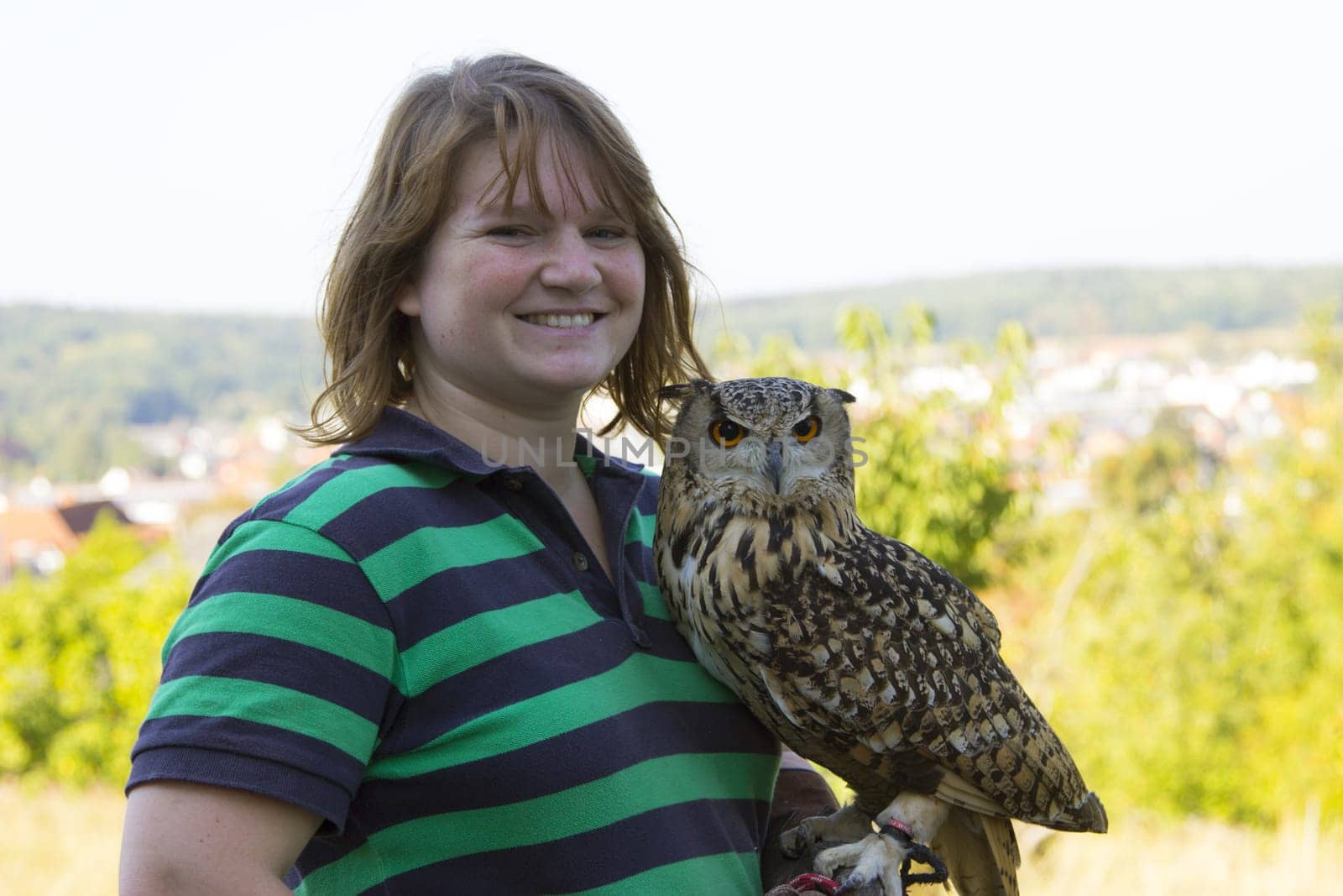 Young woman holding Indian eagle owl female