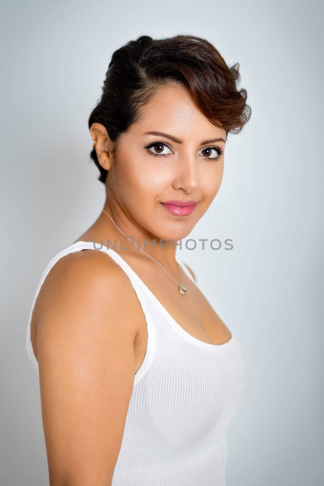 Pretty middle eastern woman on grey background