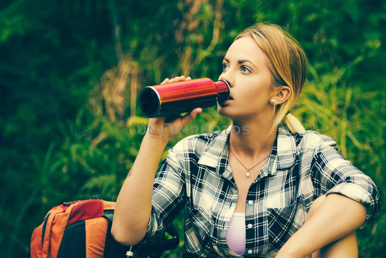 Hiker woman resting drinking water