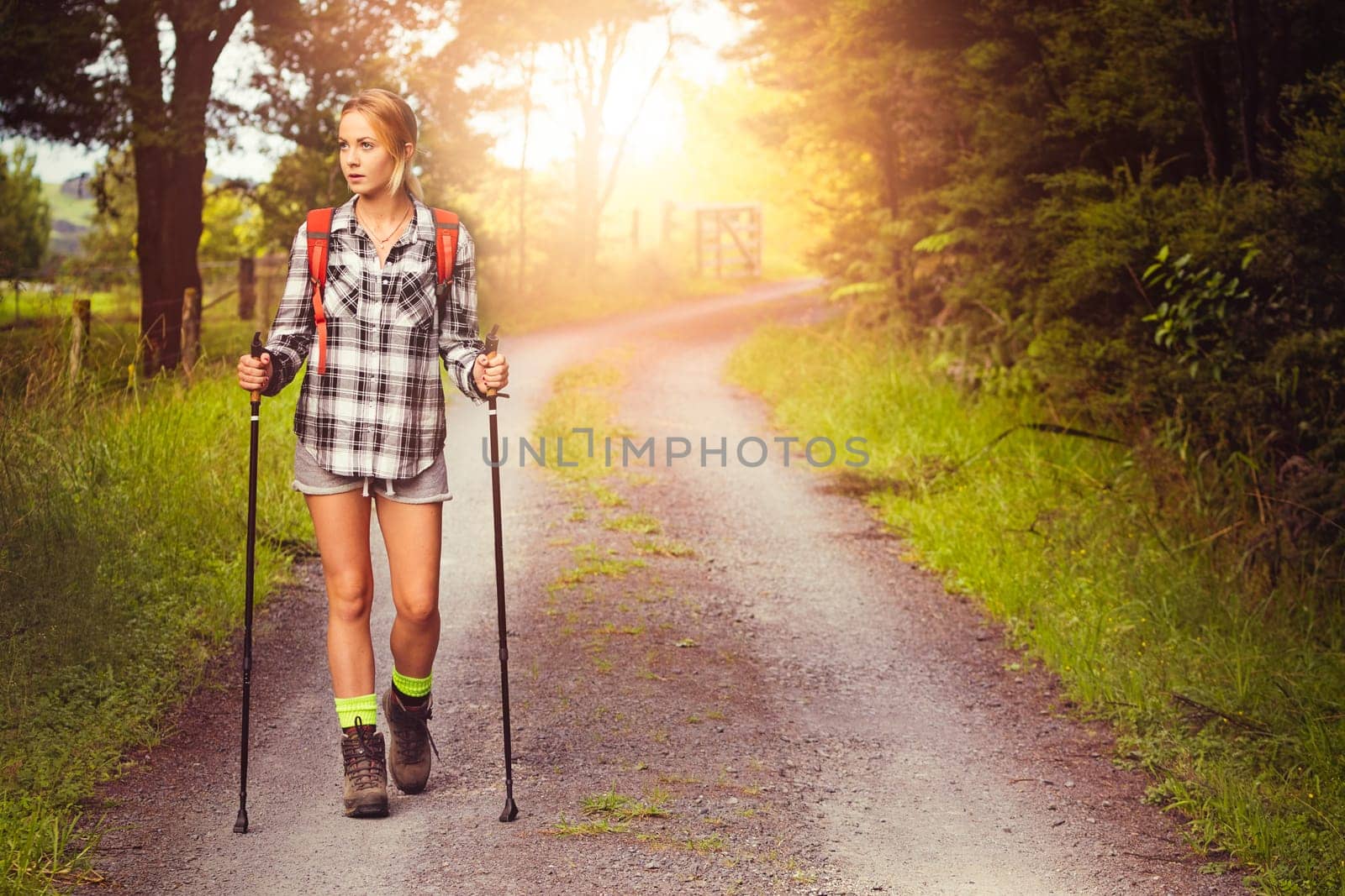 Young woman hiking on country road