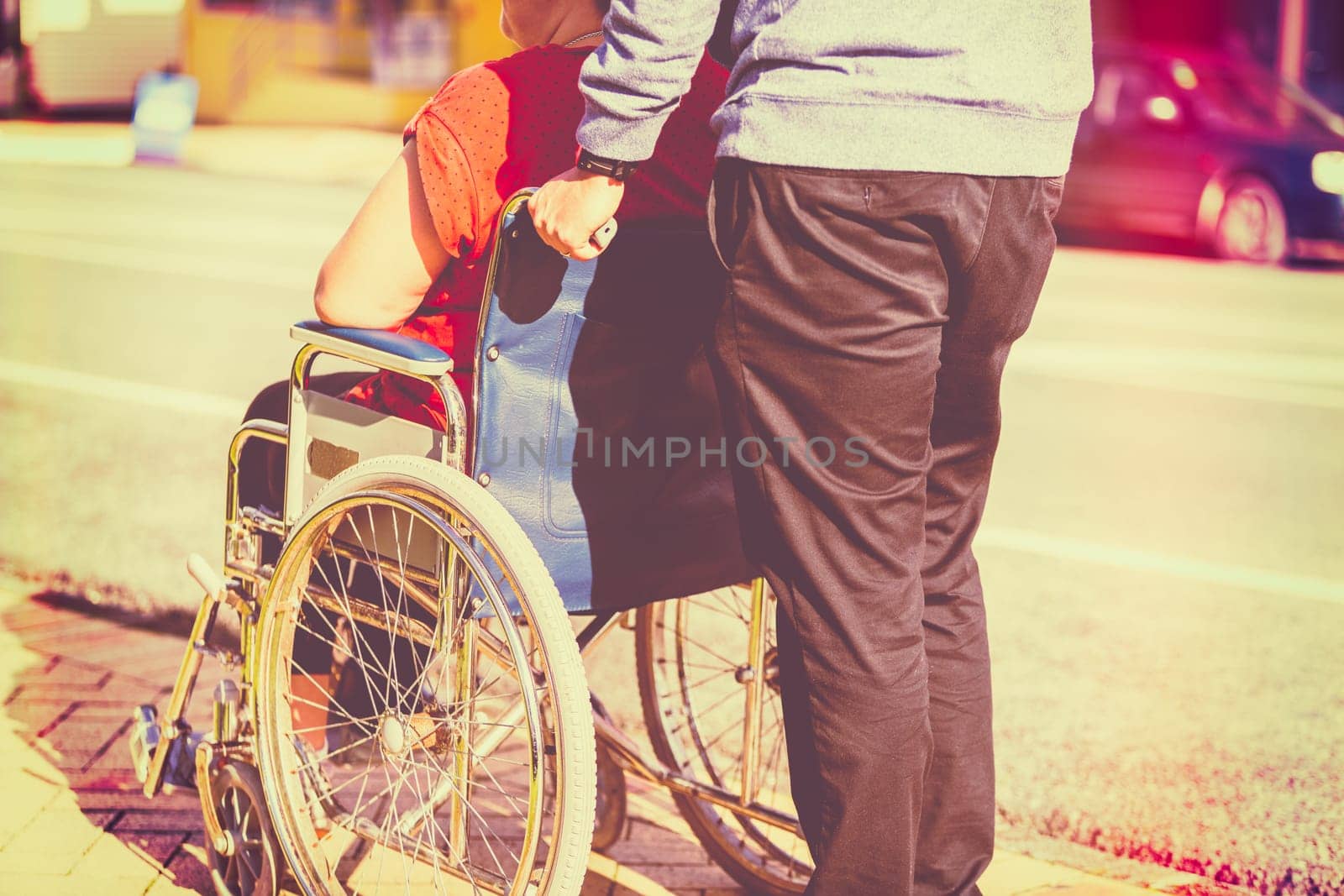 Woman in wheelchair with man pushing