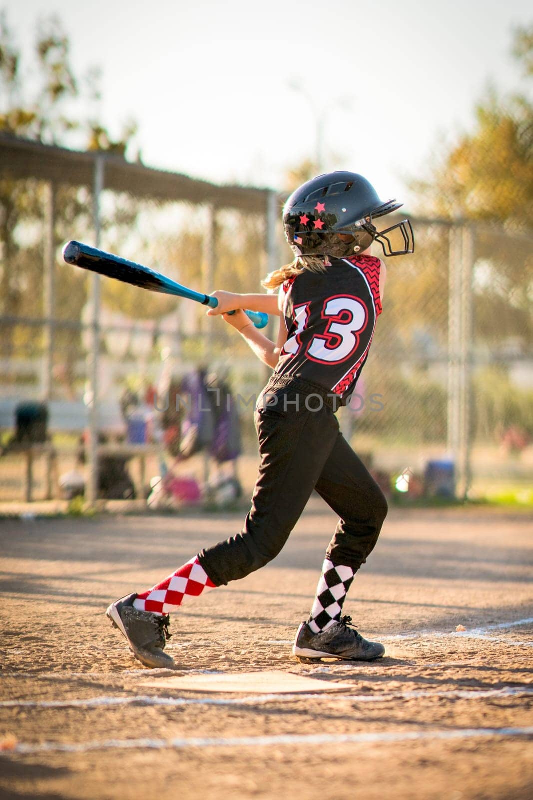 Child playing softball or baseball game