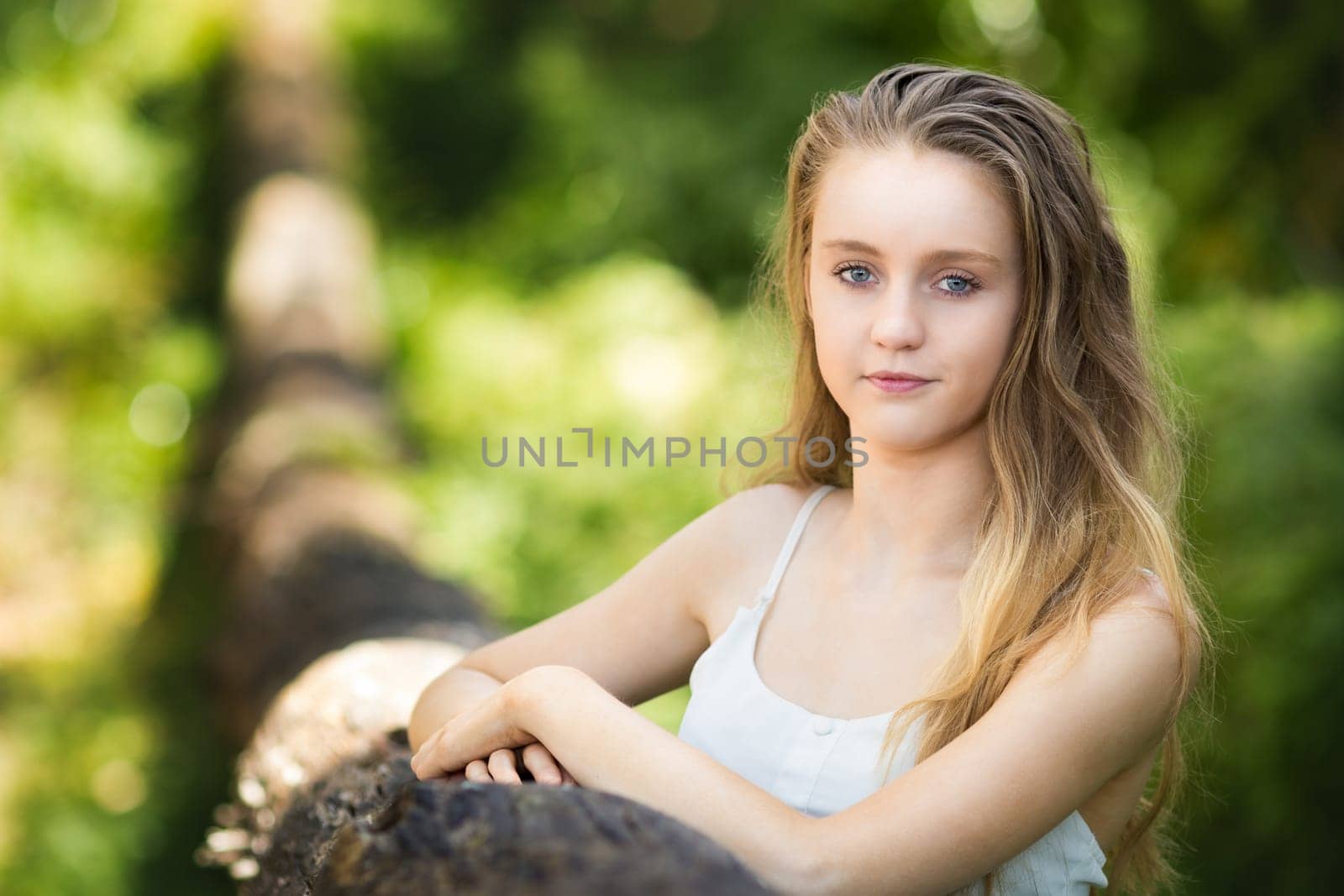 Pretty blond teen girl outside