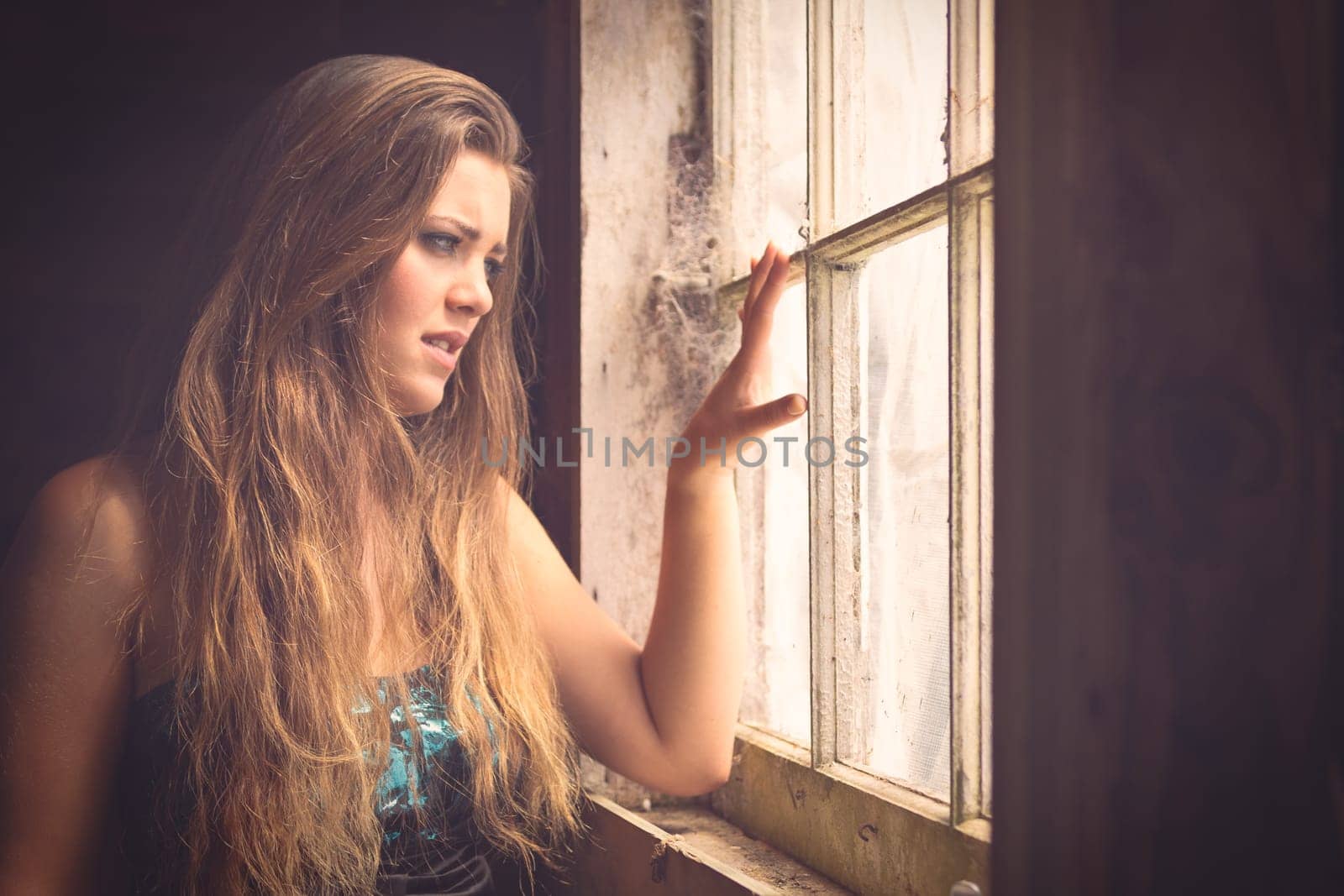 Beautiful woman looking out window