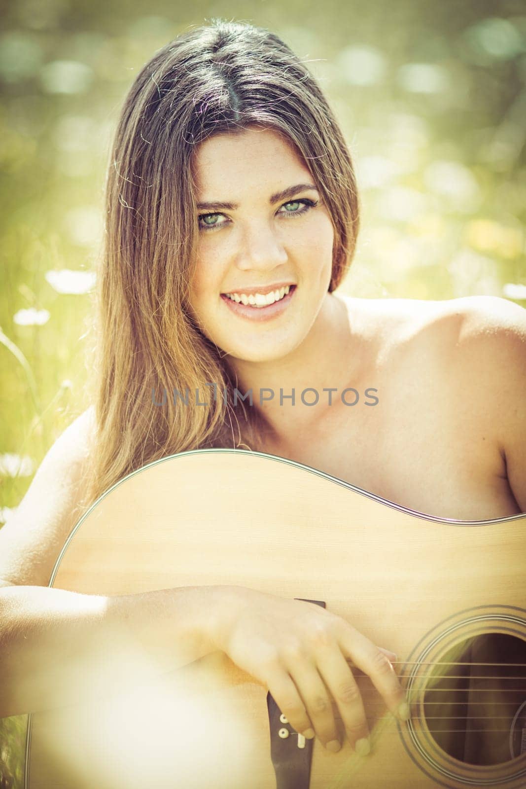 Smiling woman playing acoustic guitar