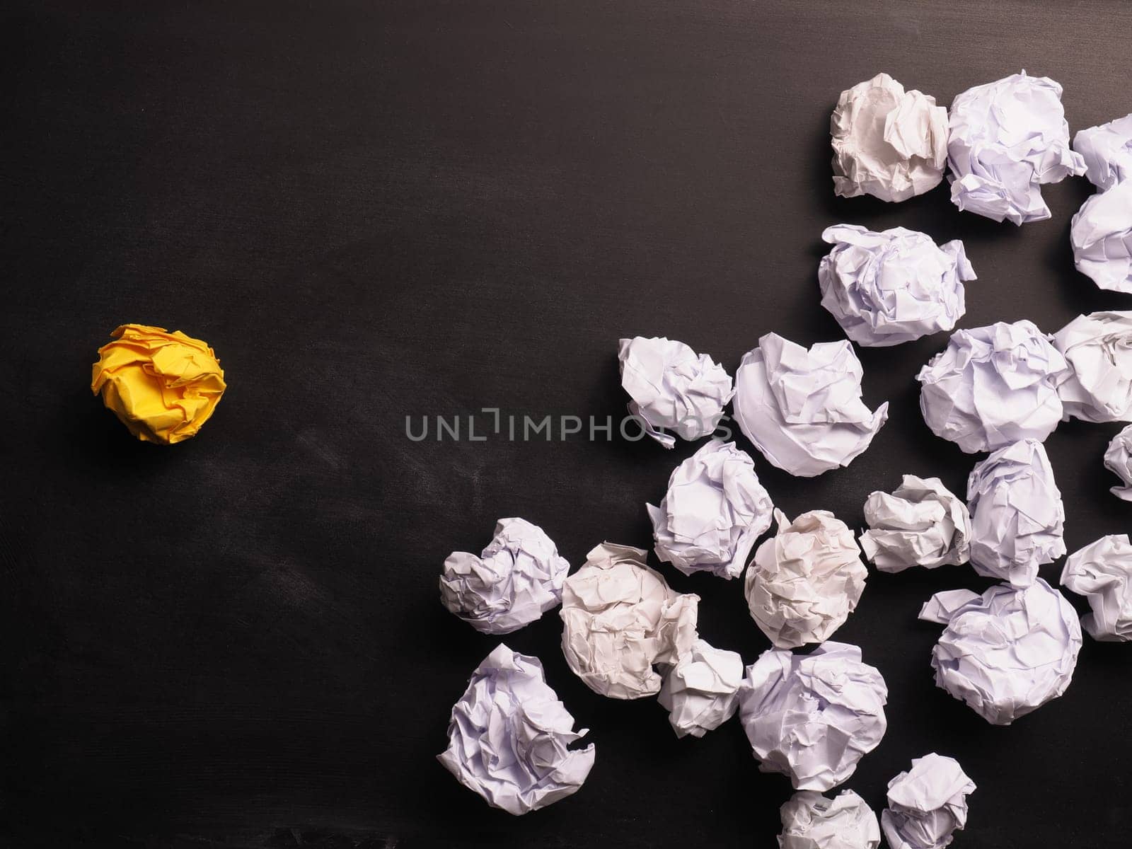 Crumpled paper on a blackboard as symbol of new great ideas