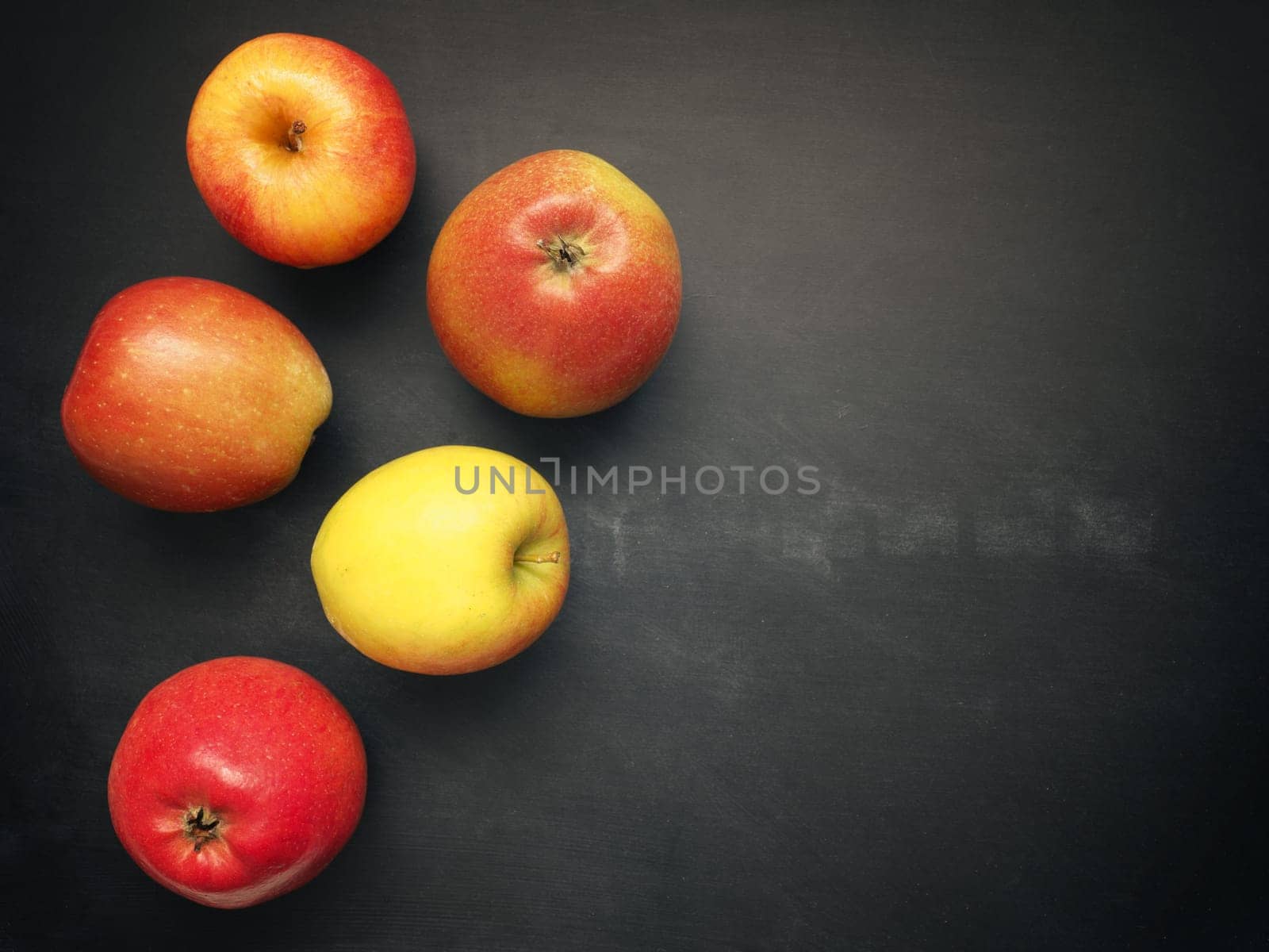 Fresh organic apples on a chalkboard, healthy food concept image