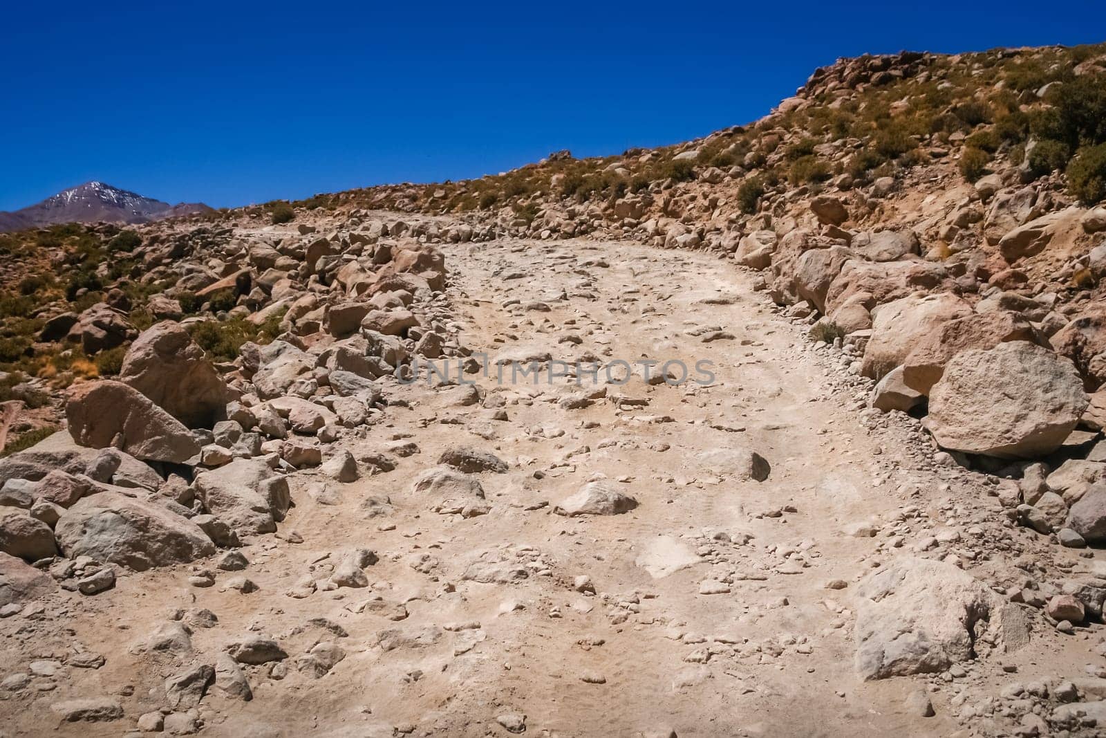 Mountain road formed of large rocks, stones and boulders through remote part of southern Altiplano, Bolivia