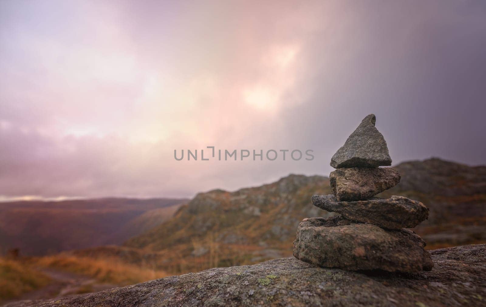 Zen balanced small pile of stacked stones on a walking path starting on top of Mount Ulriken in Bergen, Norway