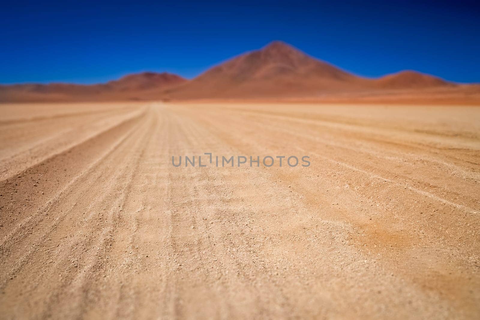 Gravel and corrugated desert road through remote part of southern Altiplano, Bolivia