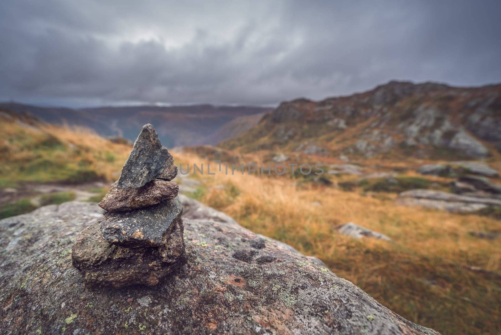 Zen balanced small pile of stacked stones on a walking path starting on top of Mount Ulriken in Bergen, Norway