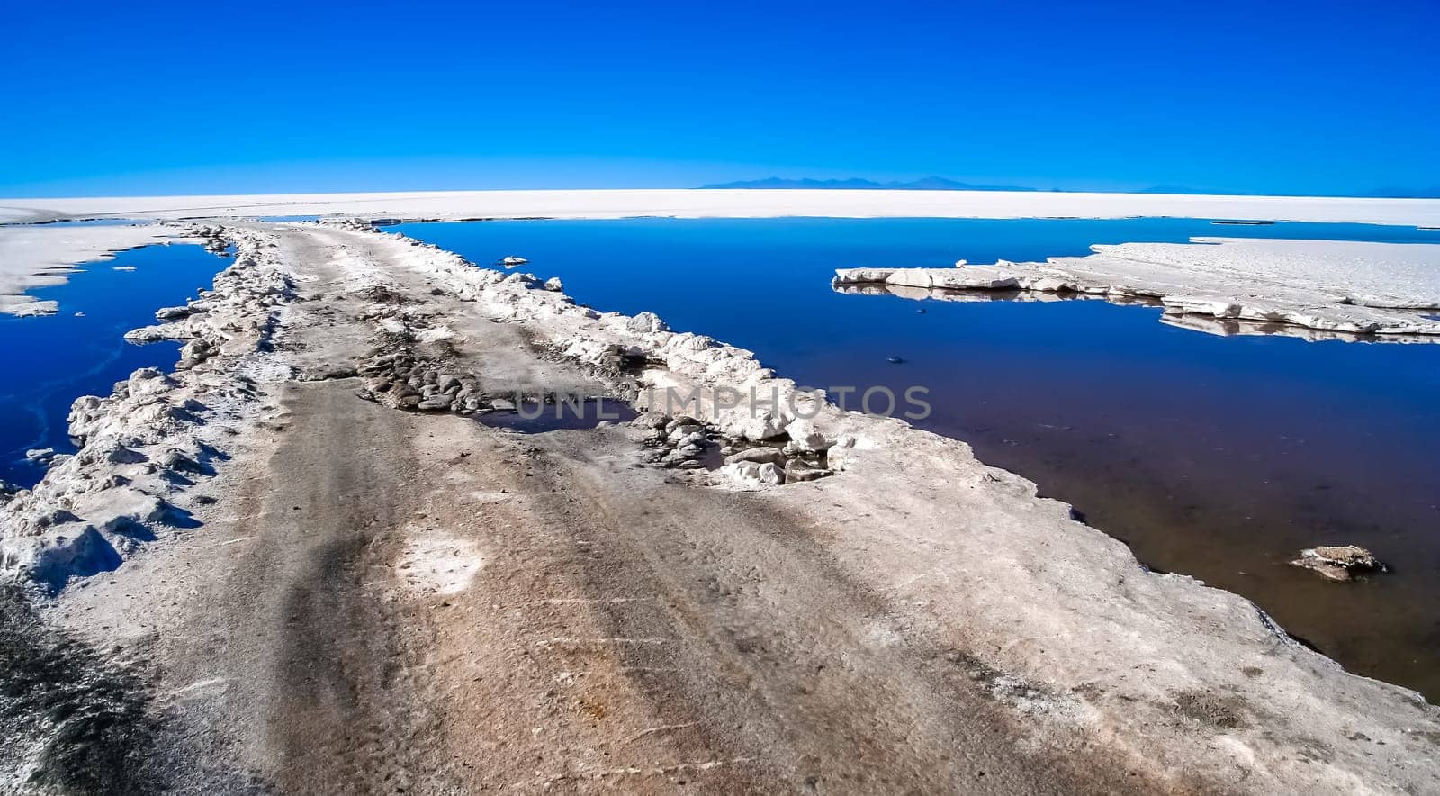 Remote empty road through the Salar de Uyuni in Bolivia