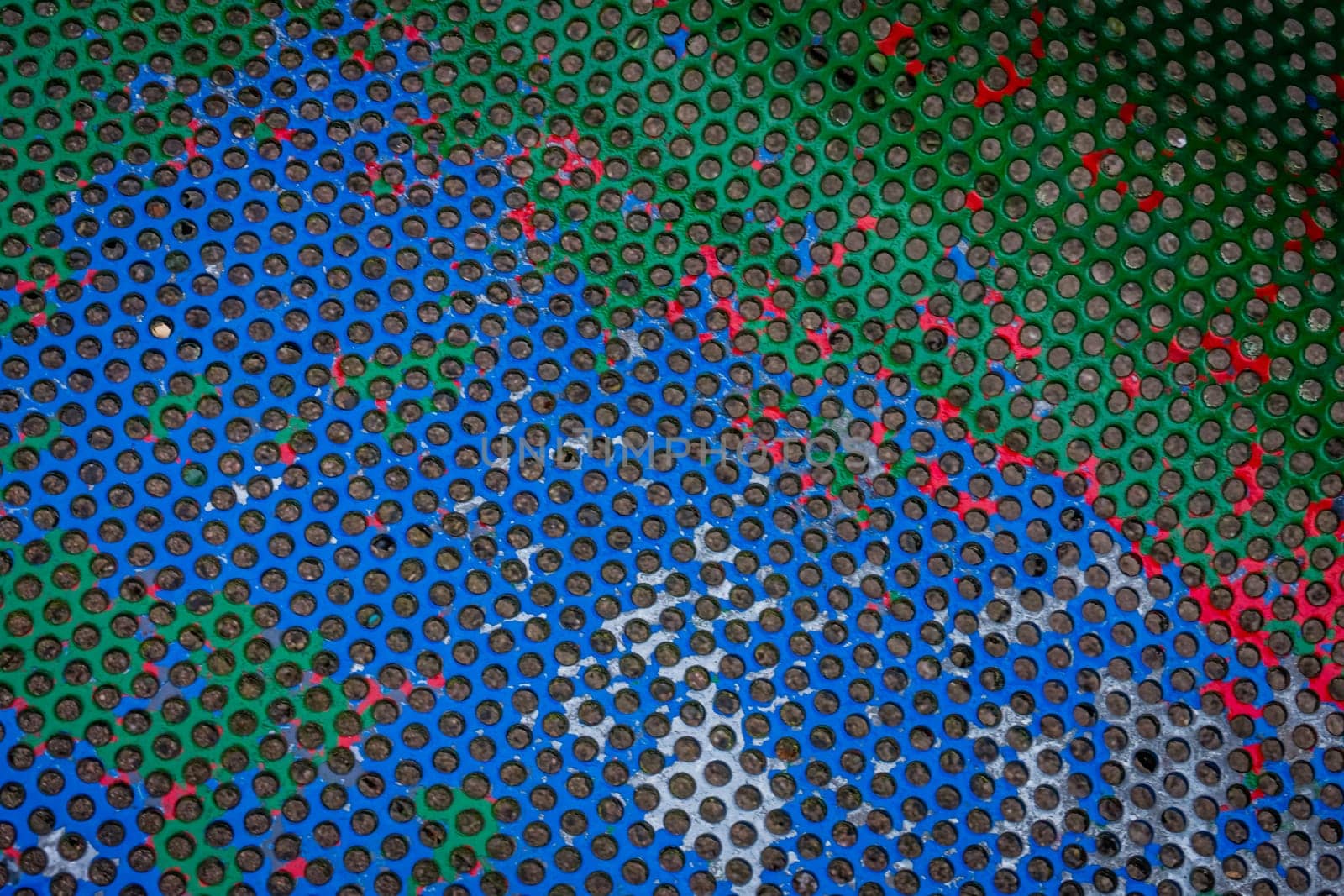 Colourful circle patterns on the painted metal bench