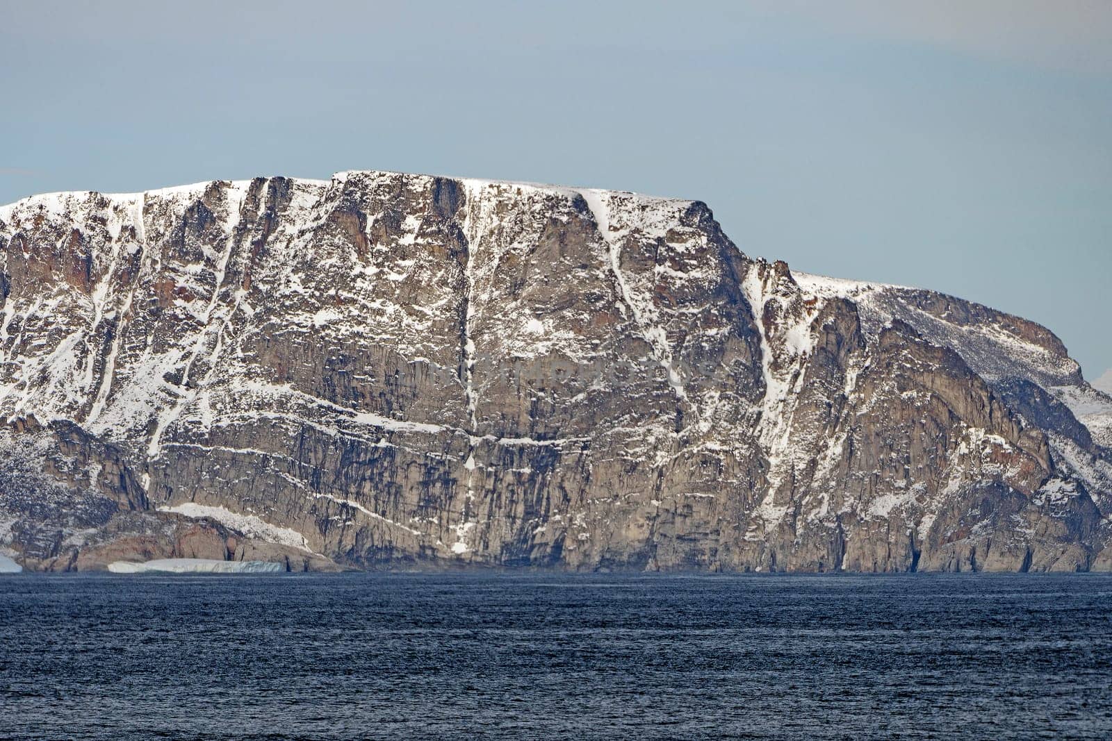 Dramatic Cliffs with Early Fall Snow on Baffin Island in Nunavut, Canada
