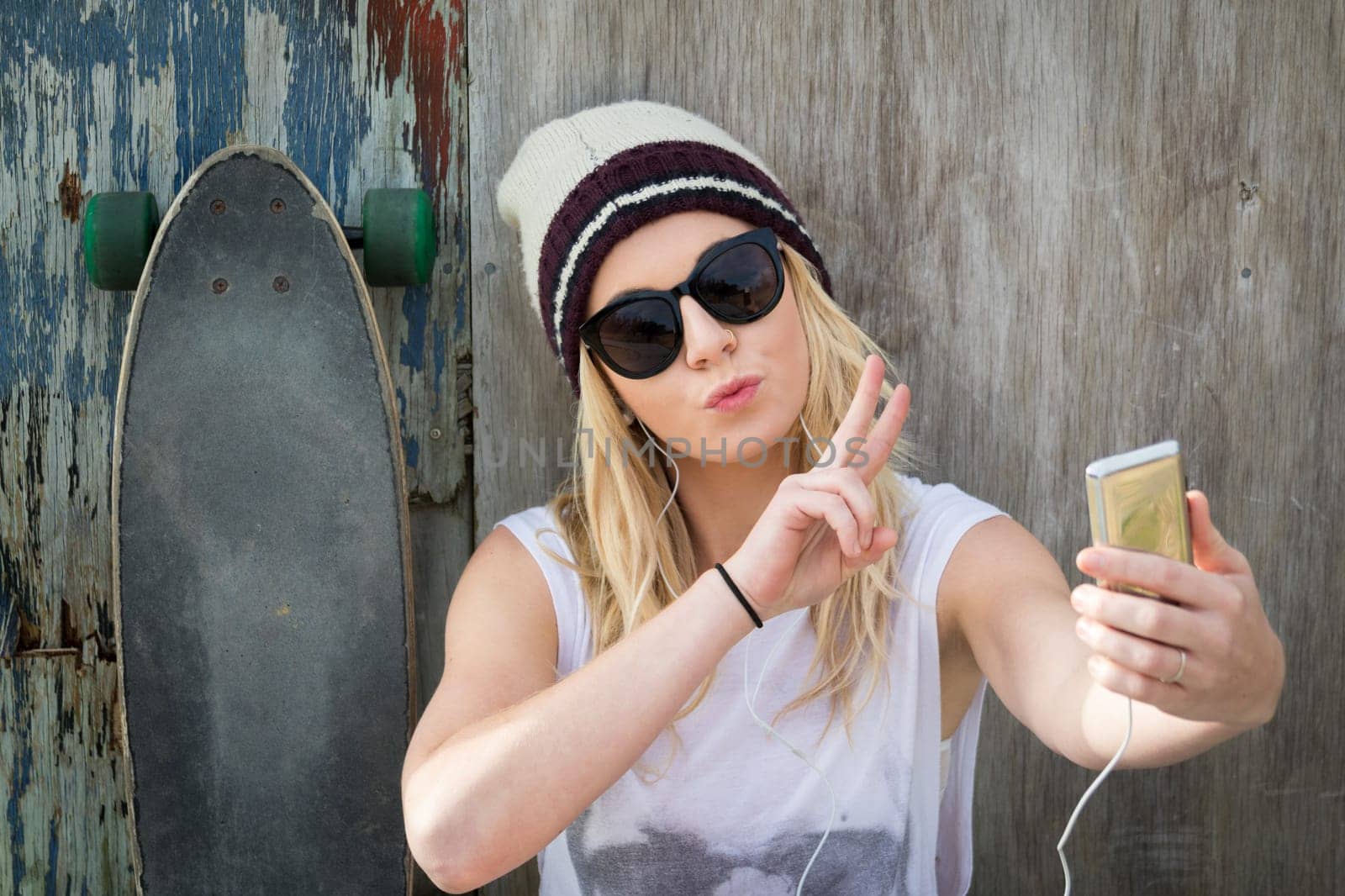 Cool skater girl taking selfie