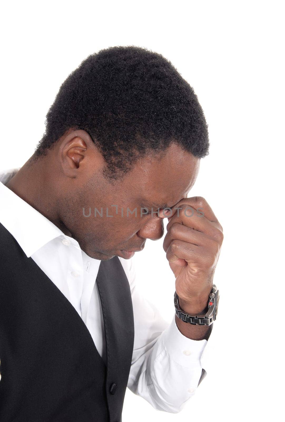 A close up of a frustrated young African American man looking down.with his hand on his forehead, isolated for white background.