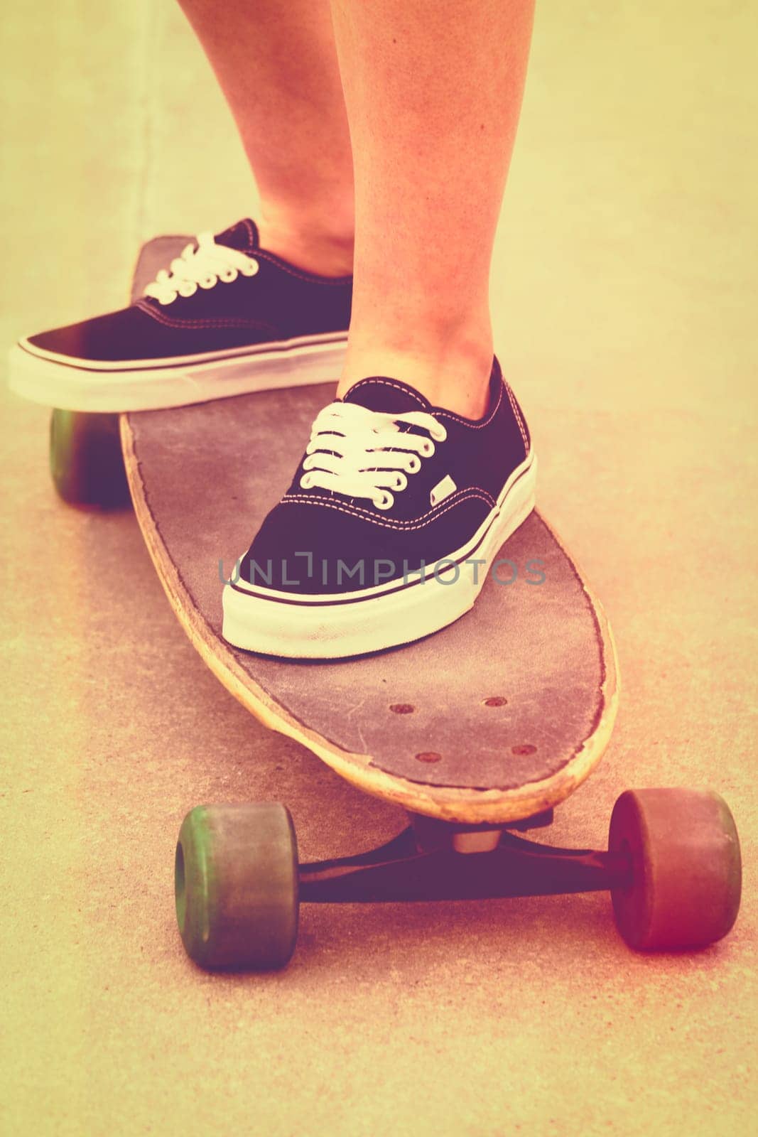 Girl riding skateboard with vintage filter