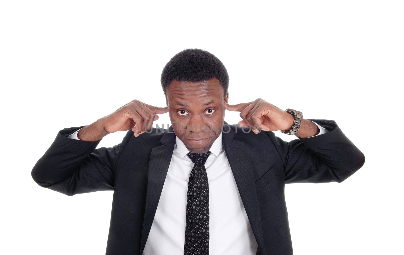 An African American man in a suit in close up putting his fingers in his.ears, don’t like to hear, isolated for white background.