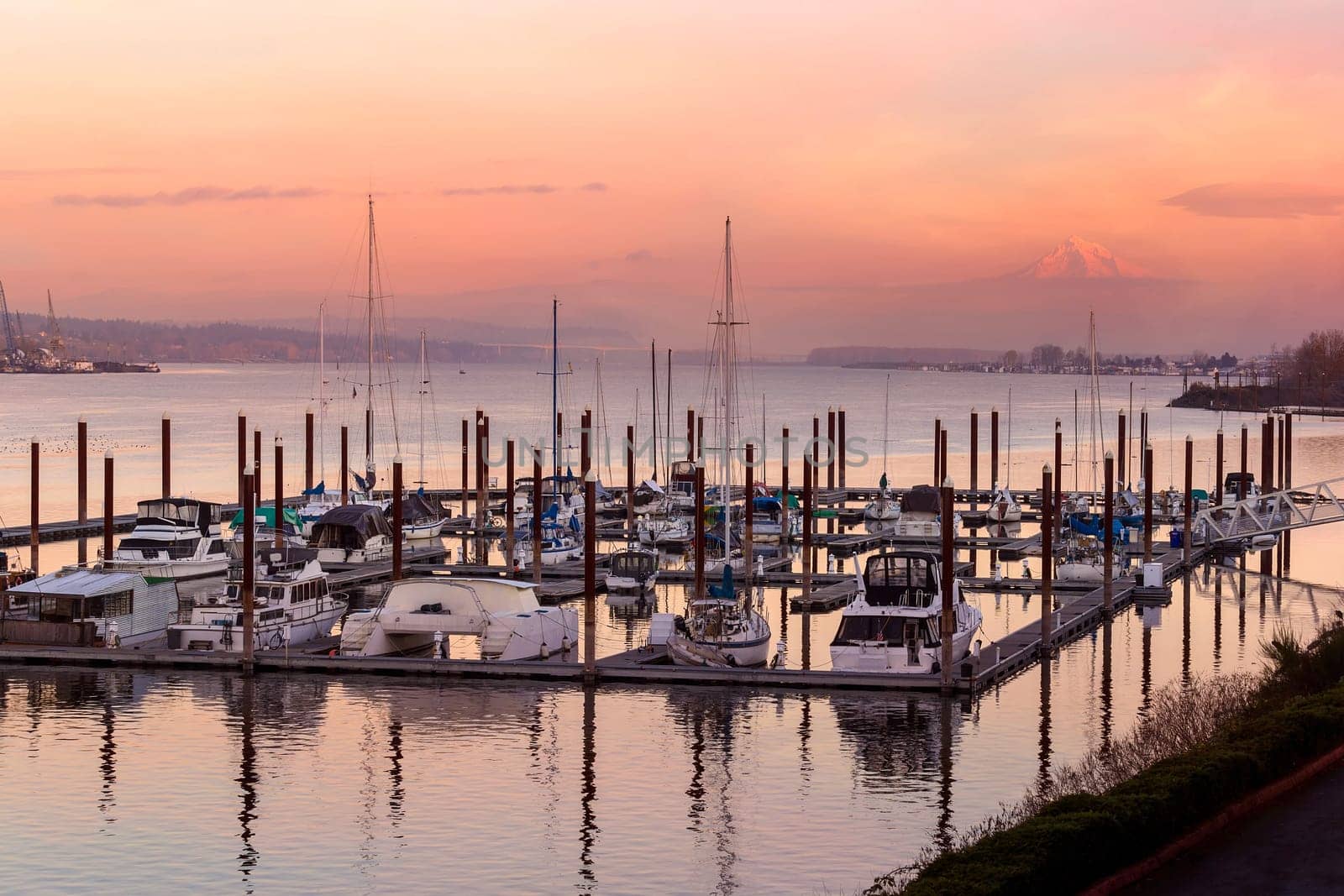 Sailboats moored at Marina along Columbia River with Mount Hood view in Oregon during sunset