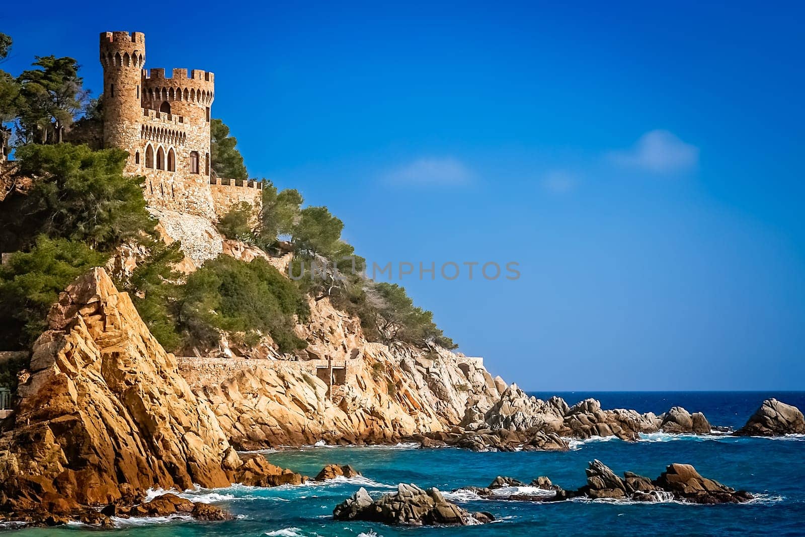Beautiful Sant Joan Castle on the rocky coast of Costa Brava in Spain