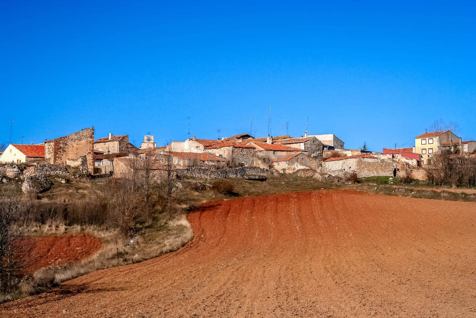 Small Spanish village and a field in an early spring