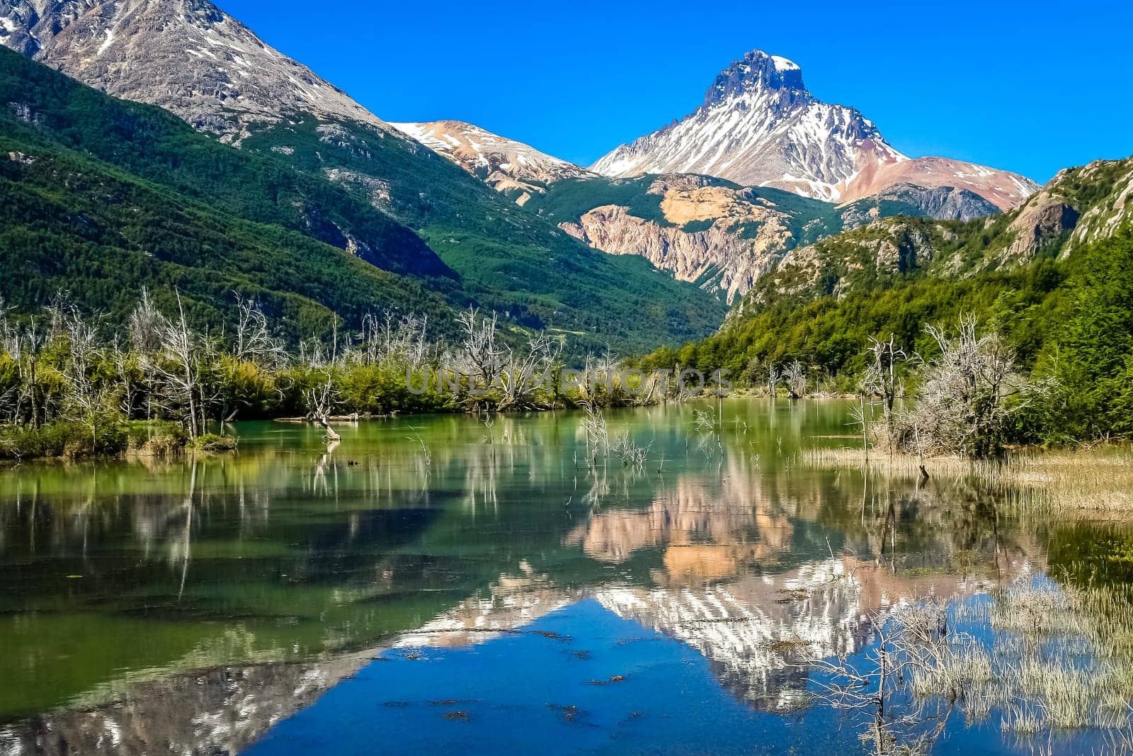 Lake reflection of mount Cerro Castillo as seen from Carretera Austral road in Patagonia, southern Chile