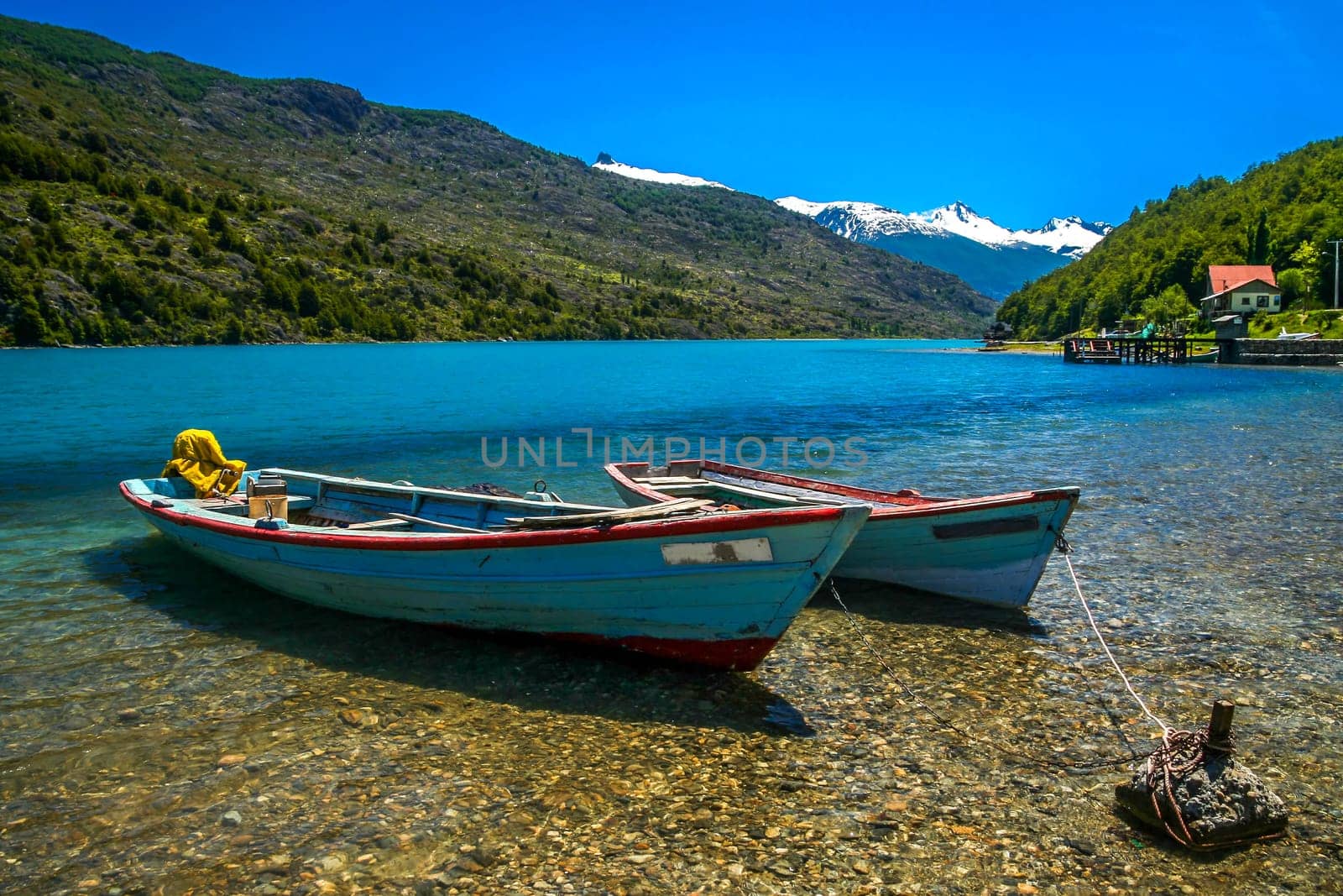 Small boats on the riverbank in Patagonian Andes