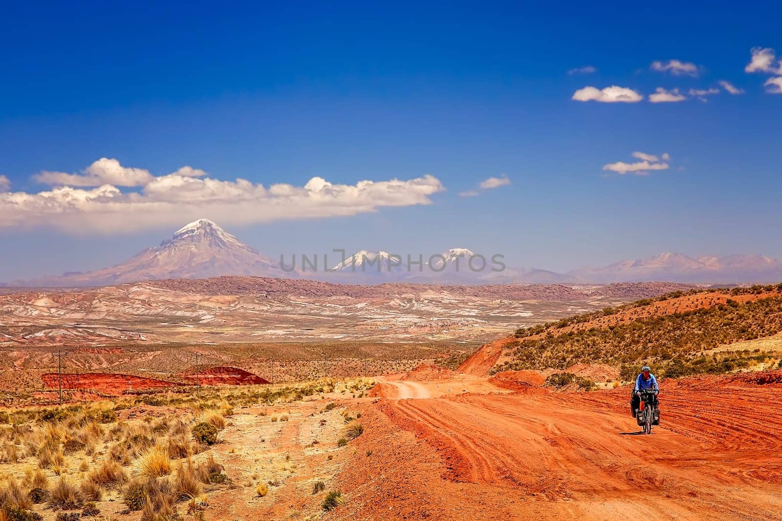 Lonely cyclist cycling through beautiful remote bolivian wilderness