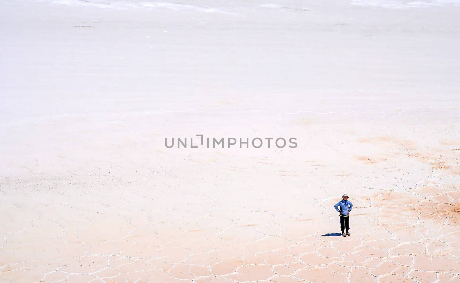 Lonely person in the middle of Salar de Uyuni in Bolivia