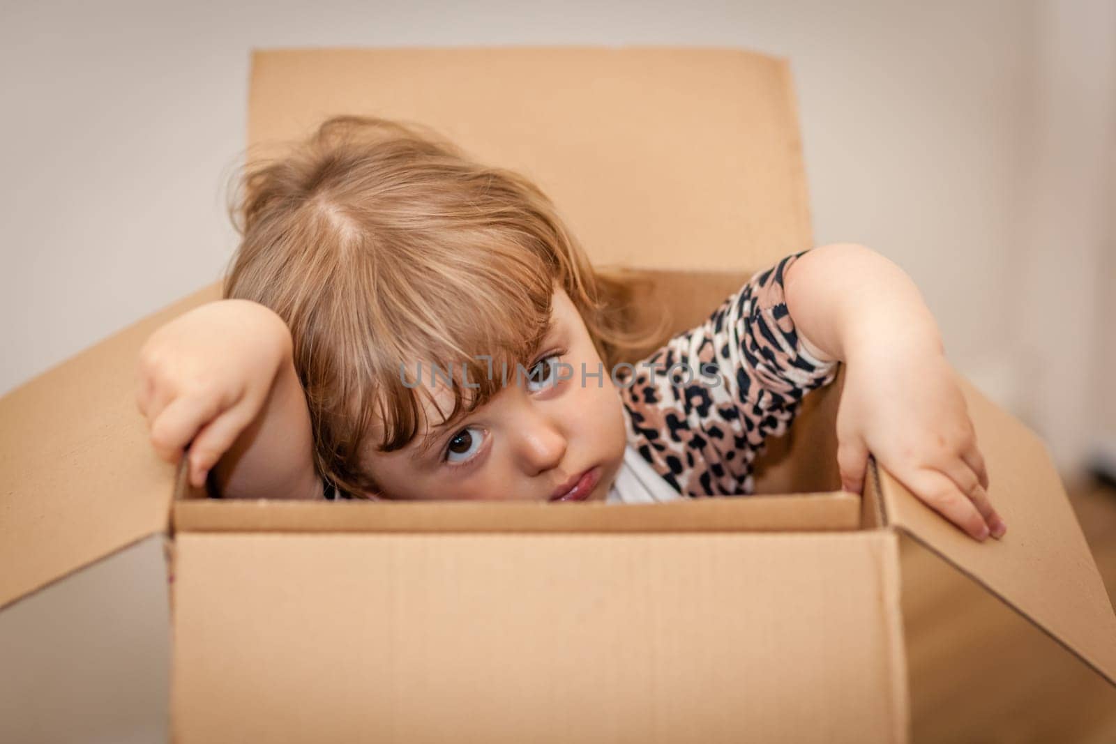 Girl popping out of a cardboard box