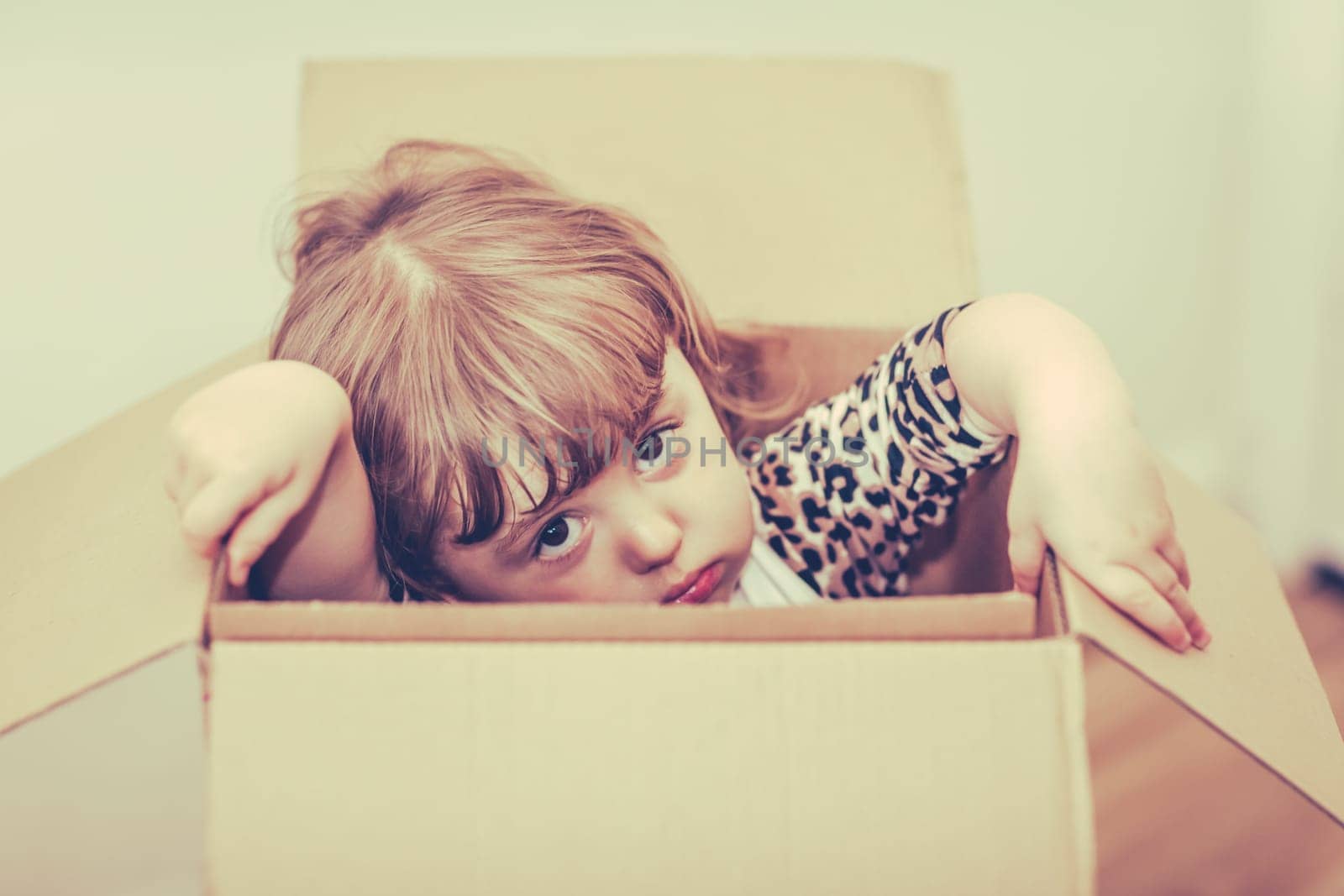 Girl popping out of a cardboard box