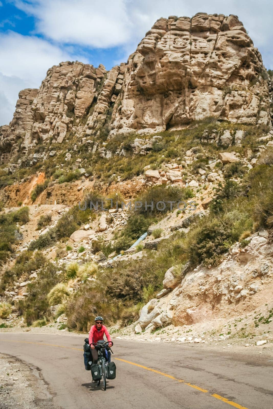 Woman cycling on the famous national Ruta 40 quarenta in the remote part of central Argentina
