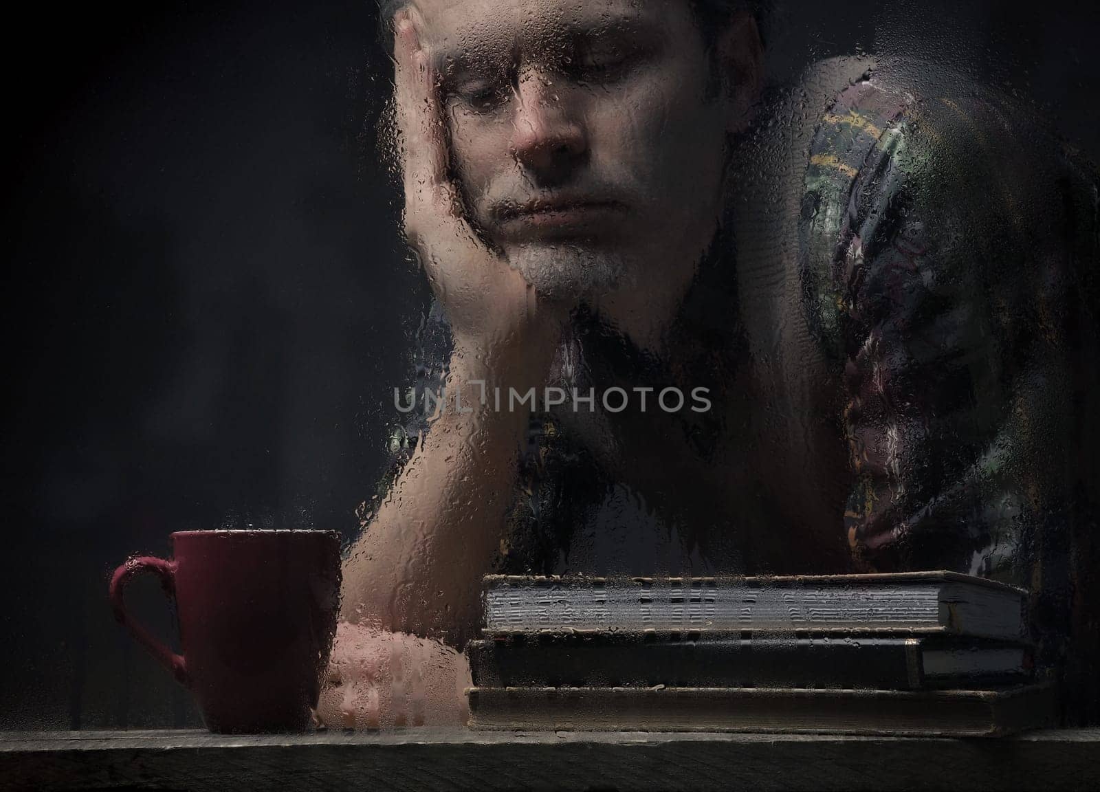 Sad man portrait on a rainy day, depression or sadness concept