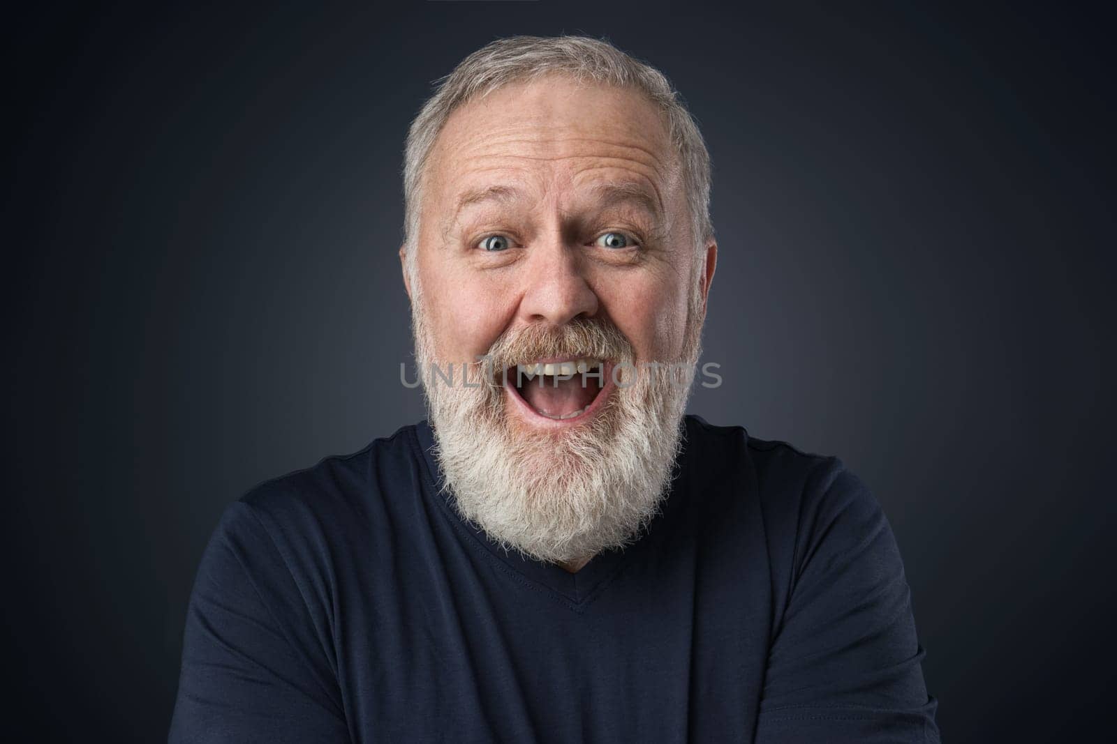 Old happy man with beard on blue background