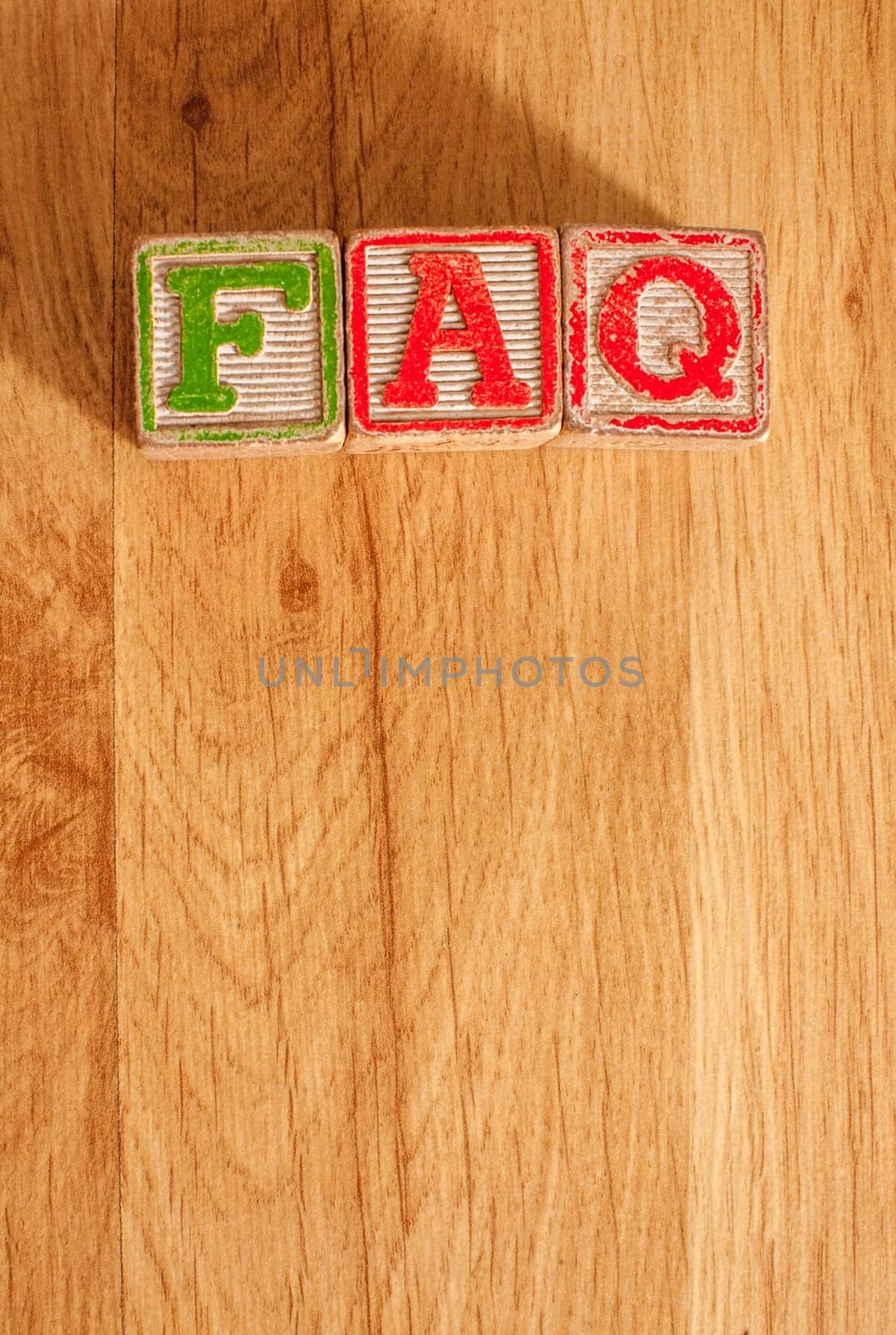 Vintage Wooden Children's Blocks spell out the abbreviation FAQ - Frequently Asked Questions