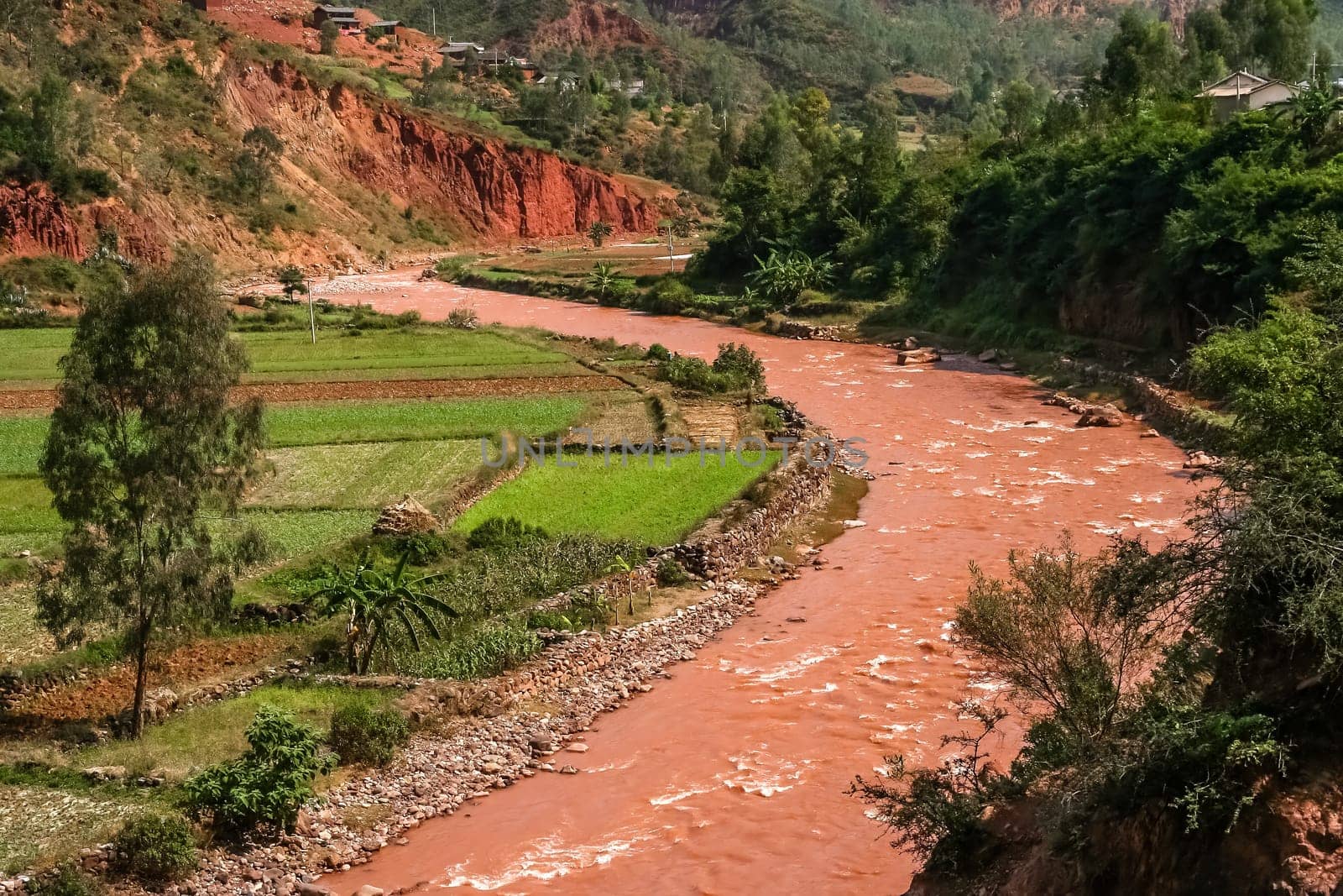 Red river flowing through the valley in Xishuabanna region of Yunnan, southern China
