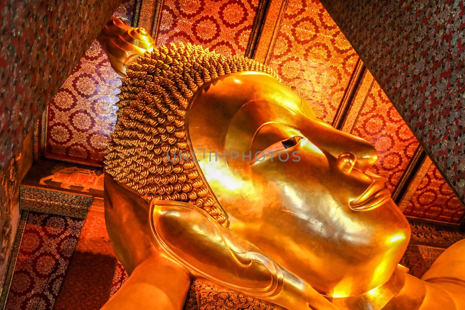 Head of the Reclining Budda in a temple in Bangkok,  Thailand
