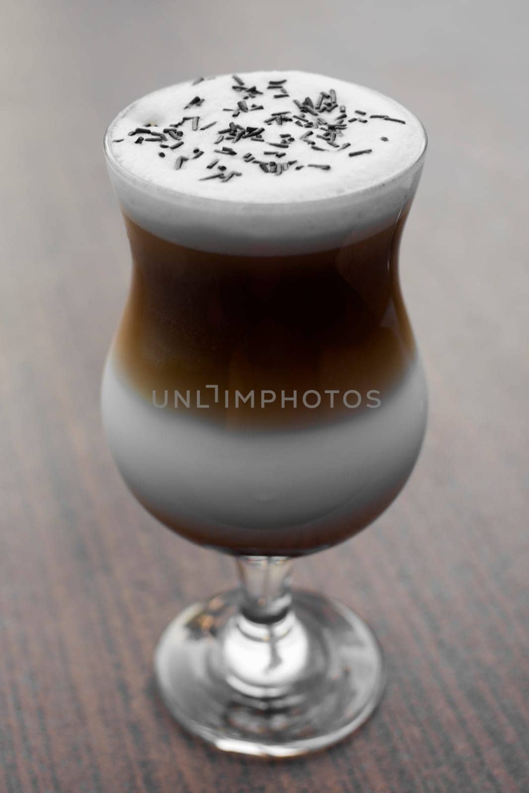Coffee latte with milk on wooden table.