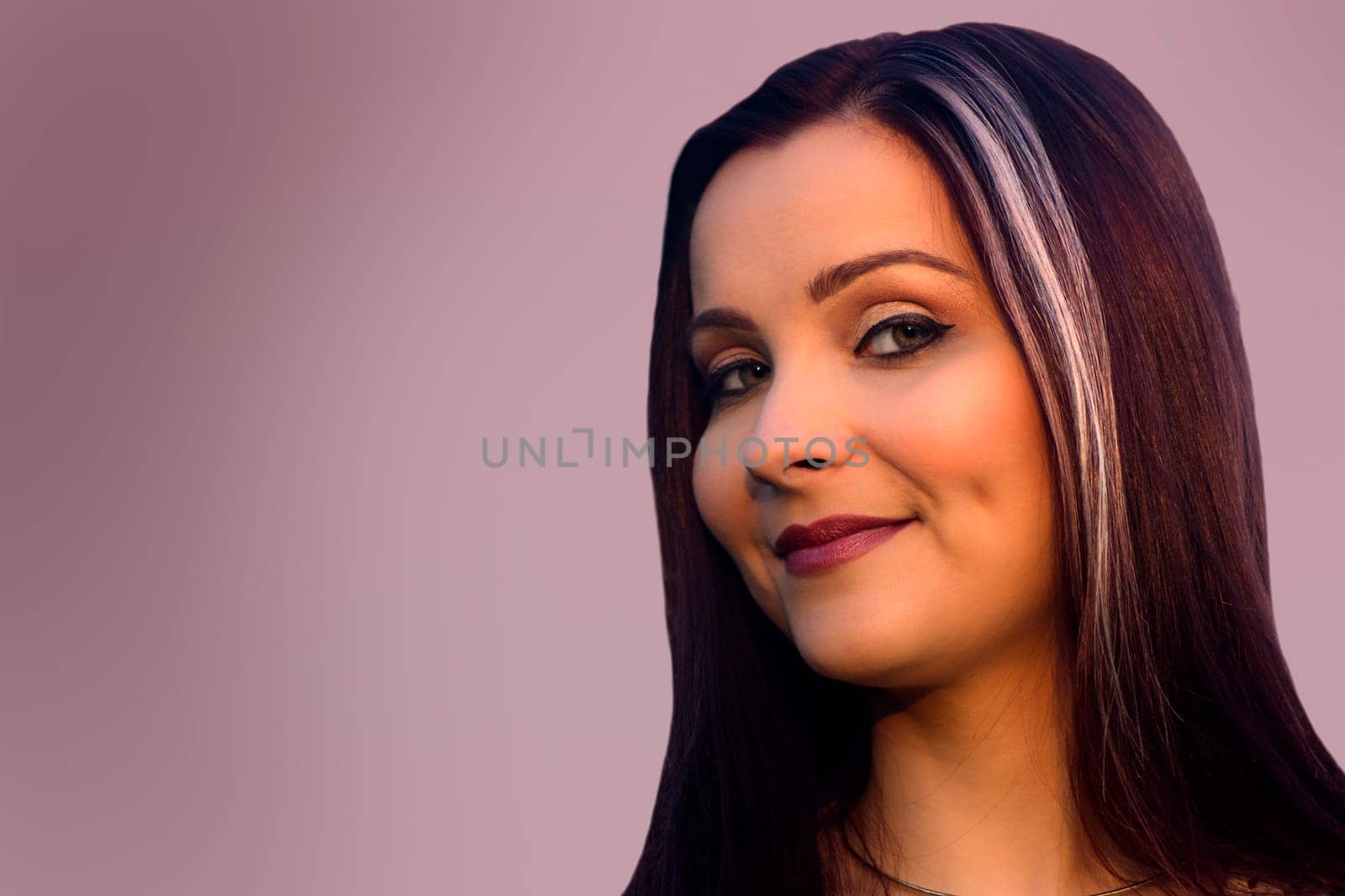 Beauty portrait about a beautiful woman on purple background.