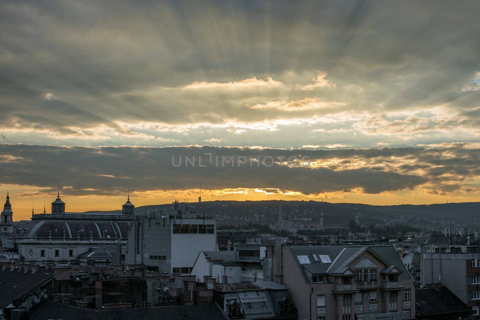 Budapest city landscape with cloudy sky at sunset.