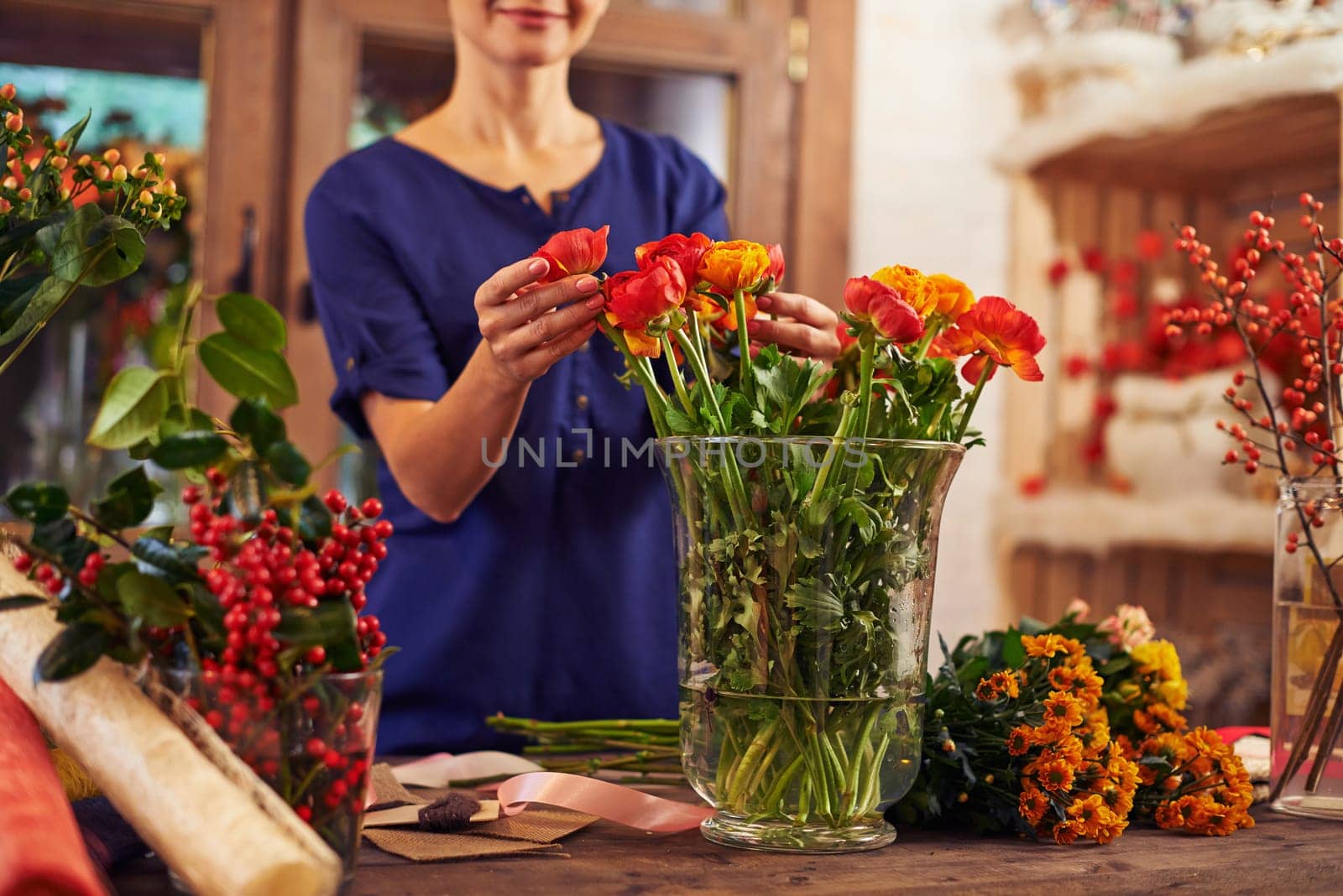 Flower seller putting flowers into a vase