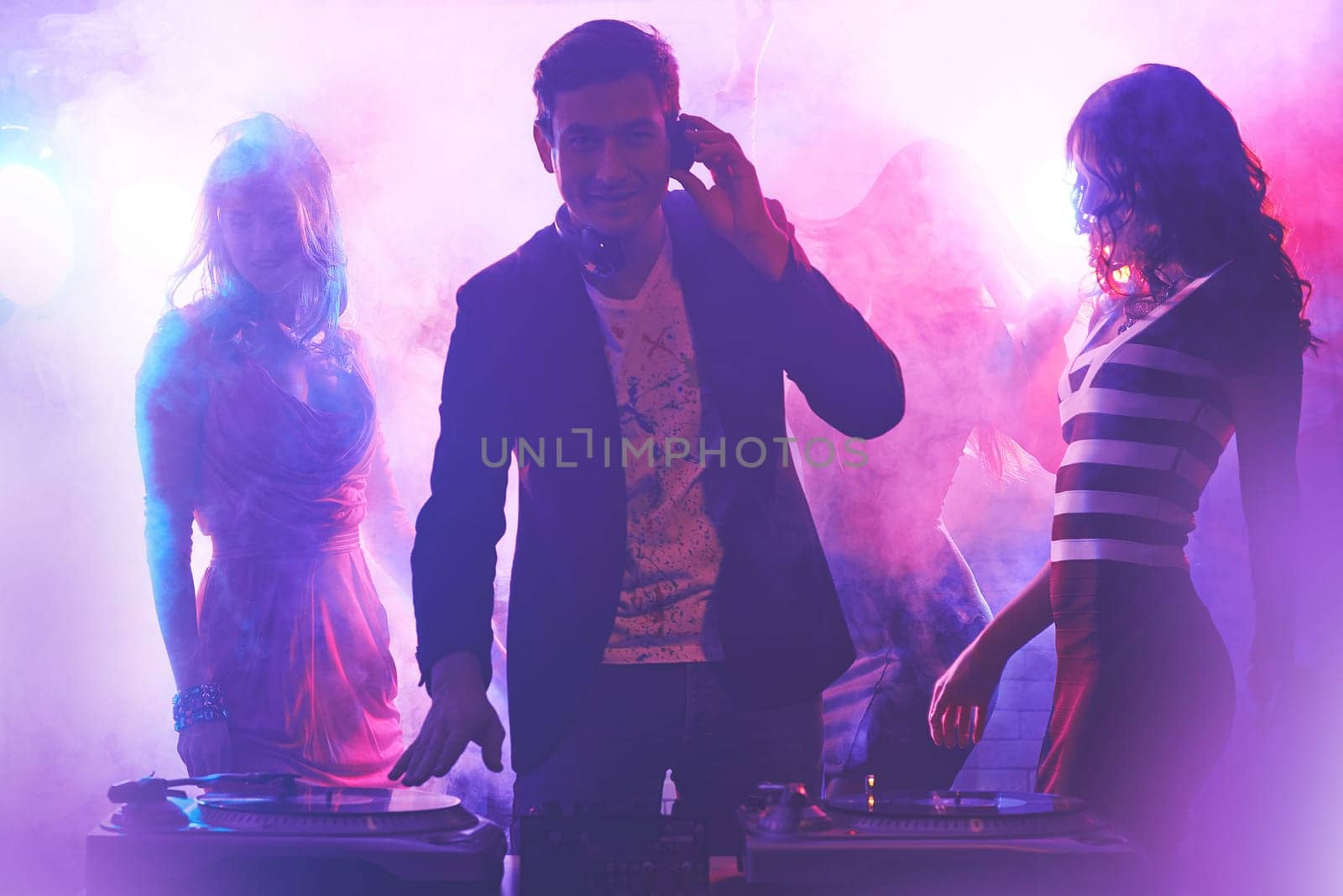 Group of girlfriends dancing in nightclub while dj playing cool music