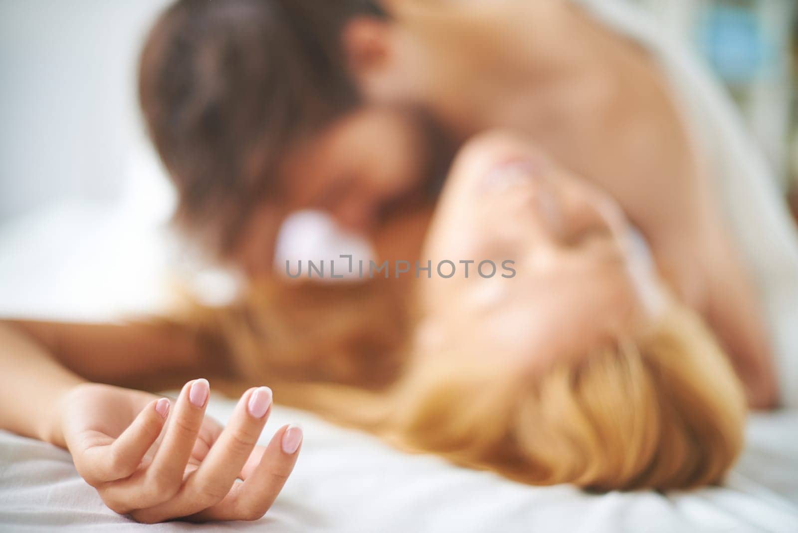 Couple kissing passionately in bed