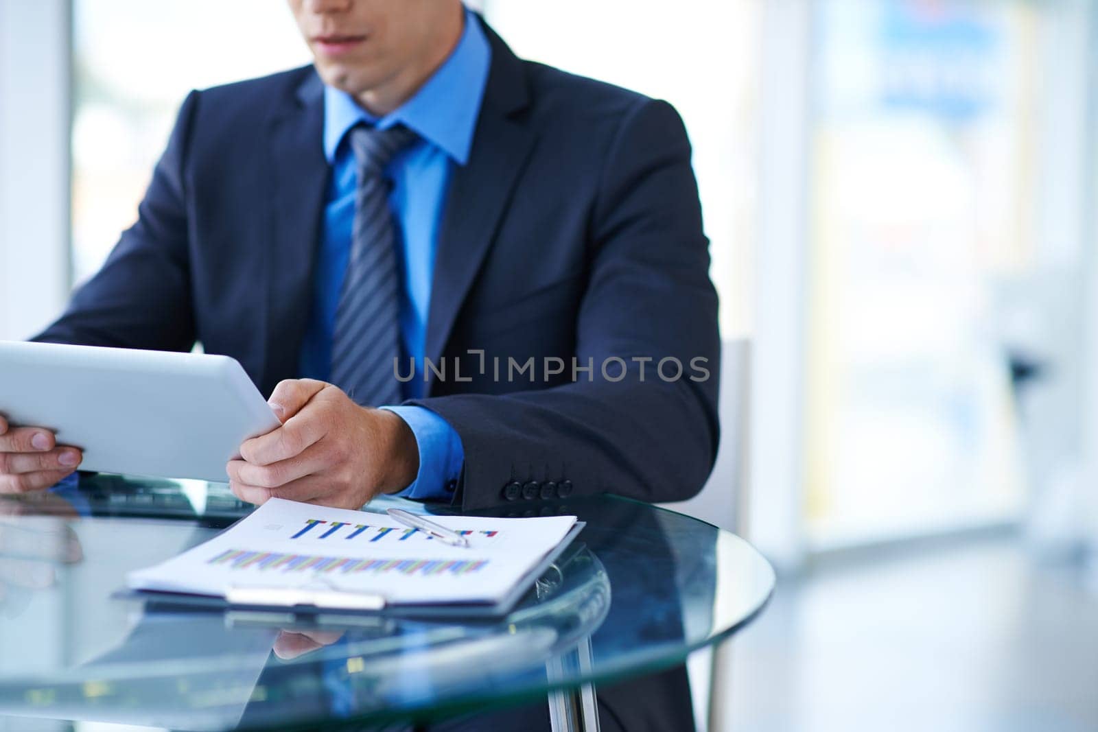 Young businessman using digital tablet at workplace