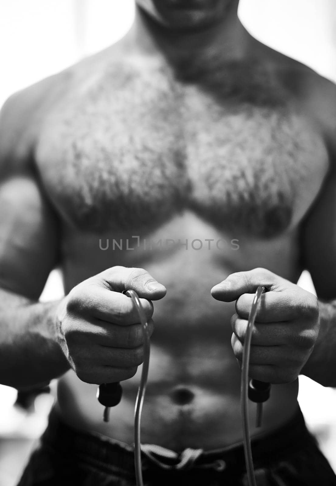 Hands of young man holding skipping rope