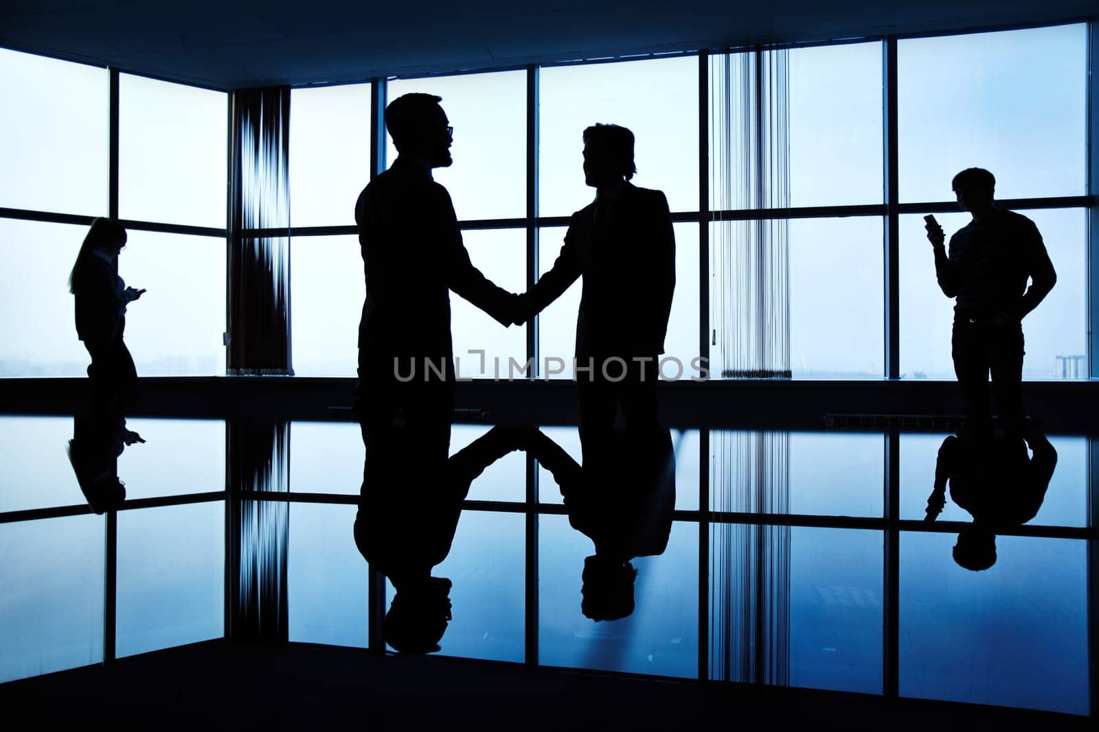 Silhouettes of business people in office