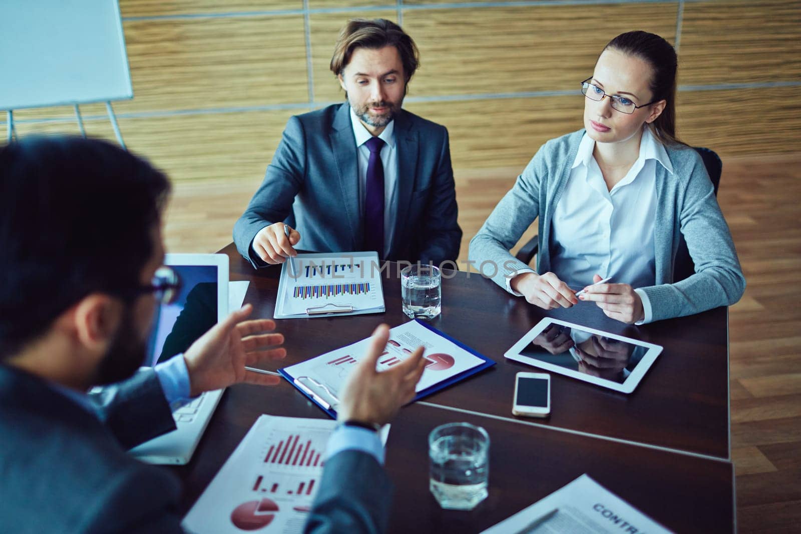 Two business people meeting with representative of company