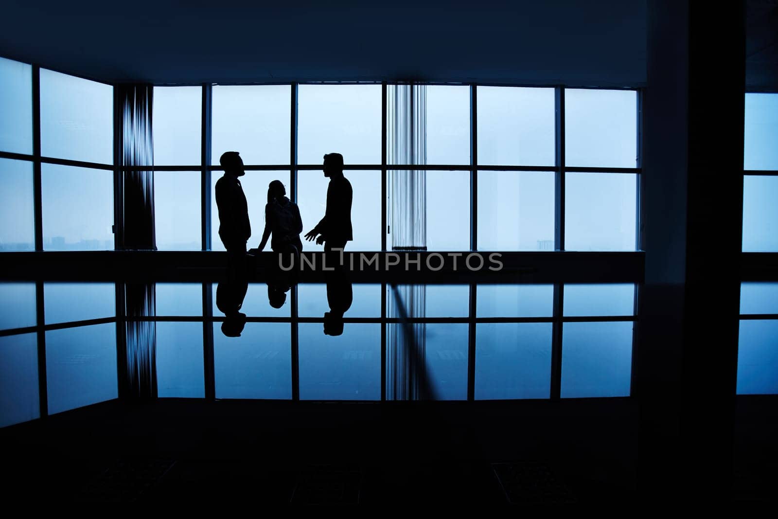 Three people meeting late in office